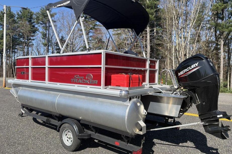 2026 Sun Tracker Party Barge 16 DLX pontoon boat with Mercury outboard motor on trailer.