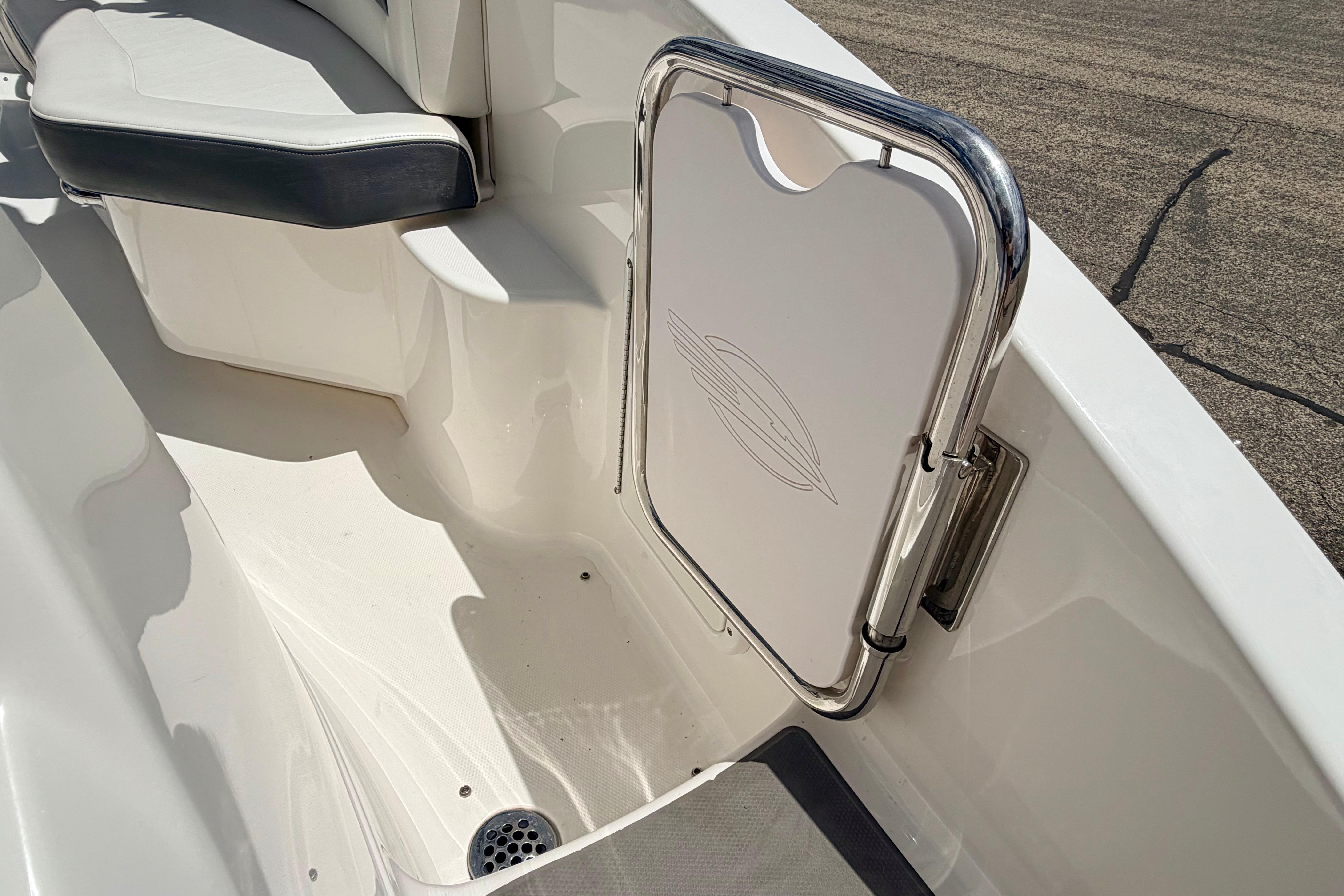 2015 Chaparral Sunesta 264 boat interior with seating and stainless steel gate.