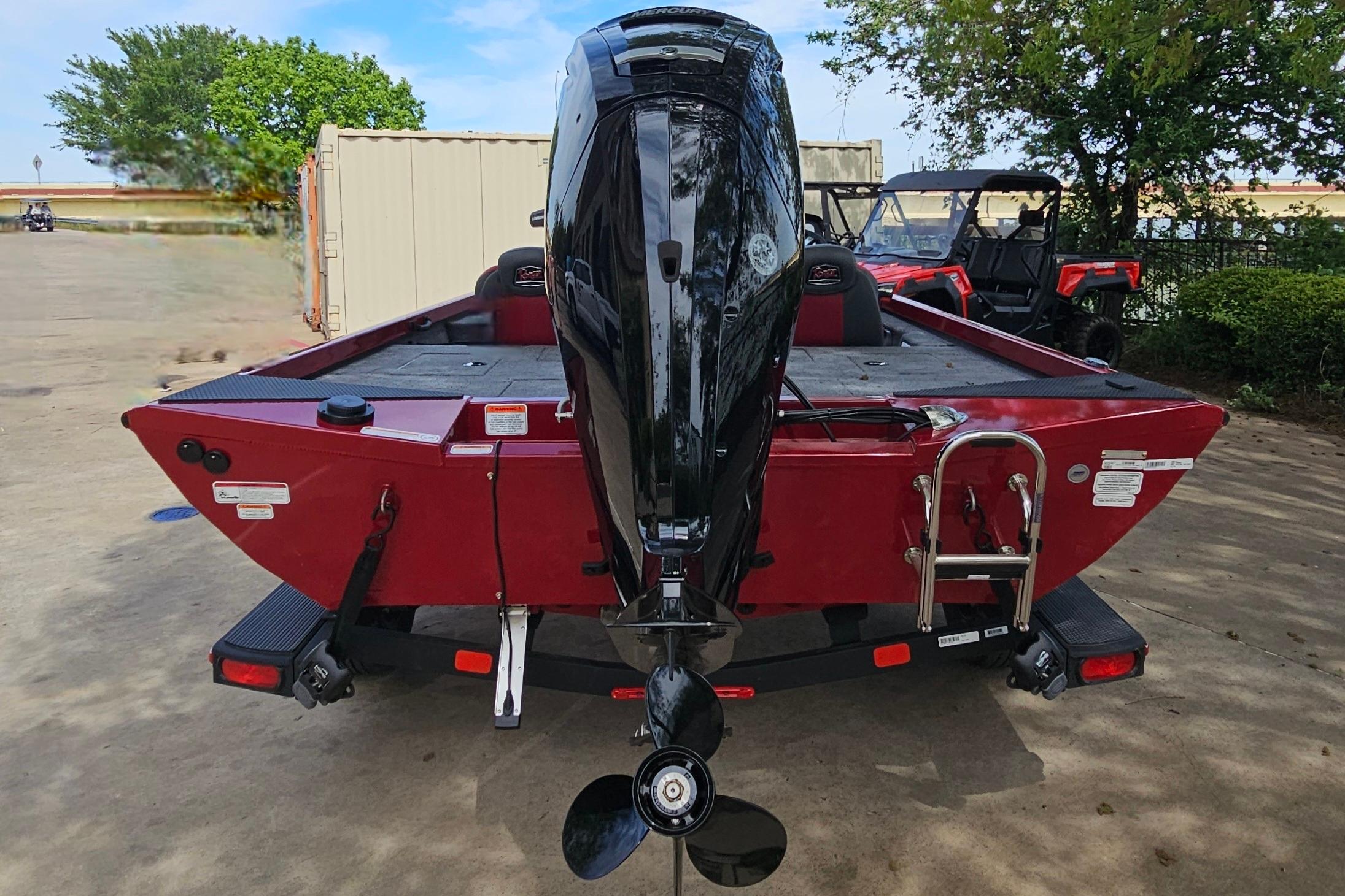 2026 Ranger RT178 boat with outboard motor, parked outdoors.