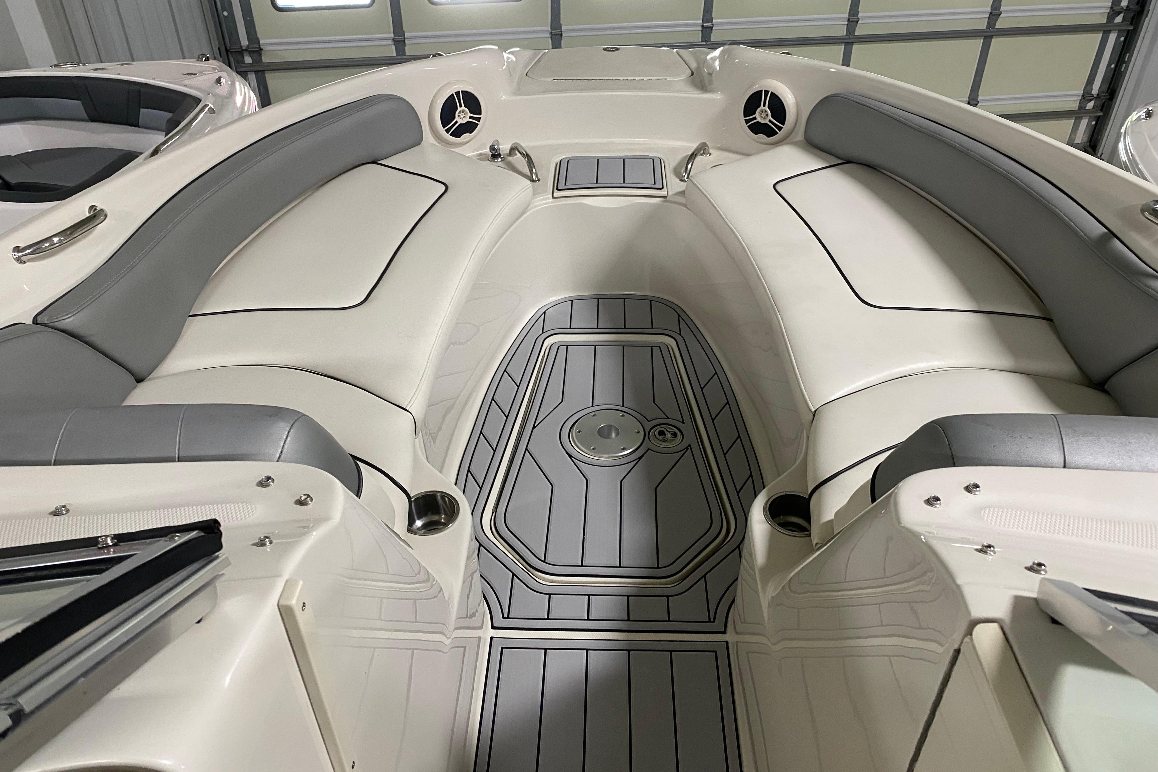 Interior view of a 2008 Sea Ray 240 Sundeck boat with gray and white seating.
