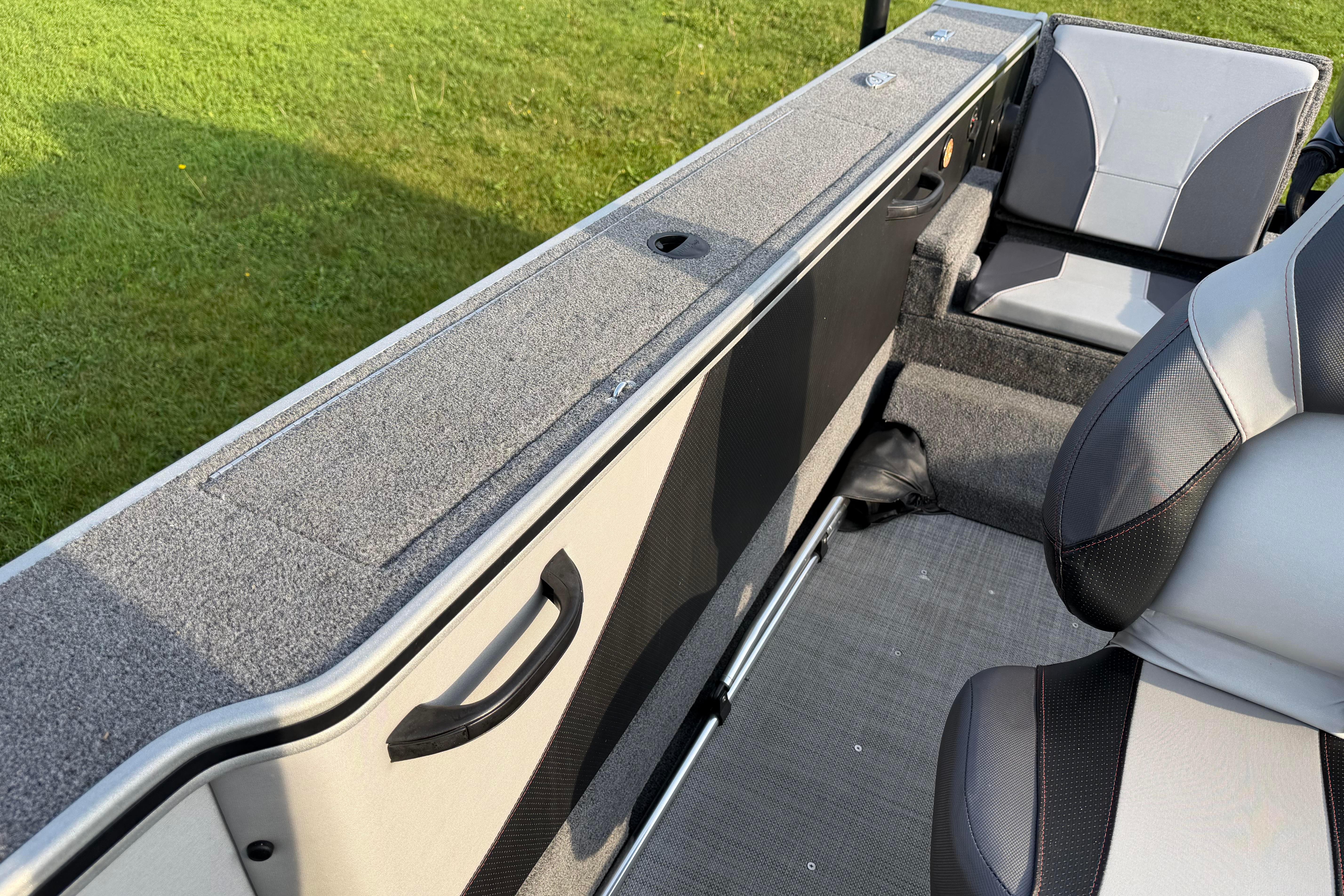 2019 Alumacraft Trophy 205 boat interior with gray seating and storage compartments.