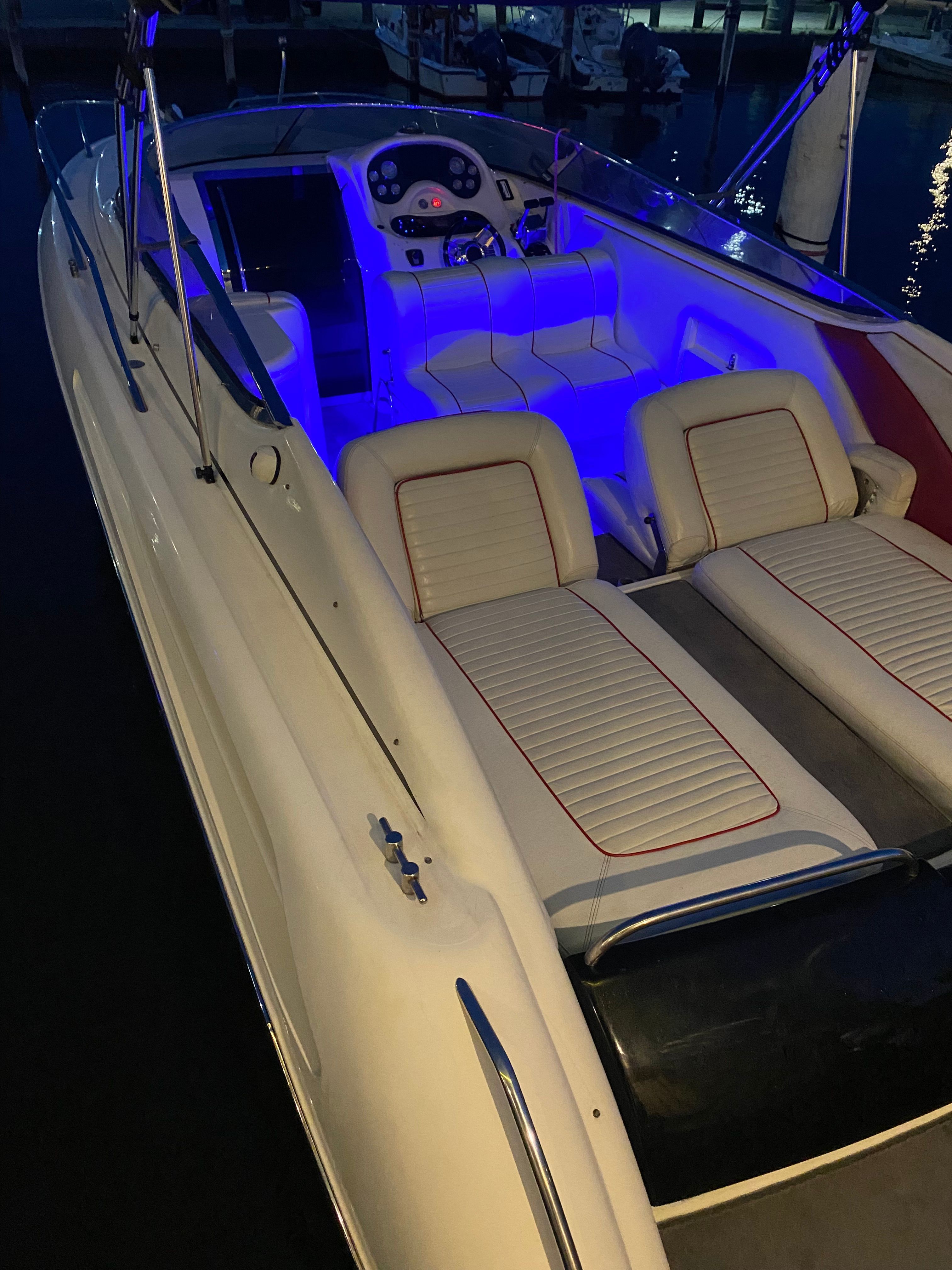 1994 Sunseeker Hawk 31 with blue interior lighting at the dock.