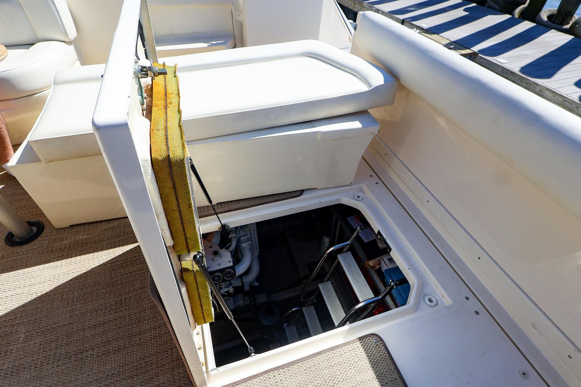 Open engine compartment on 1998 Sea Ray 500 Sundancer yacht, showcasing interior access.