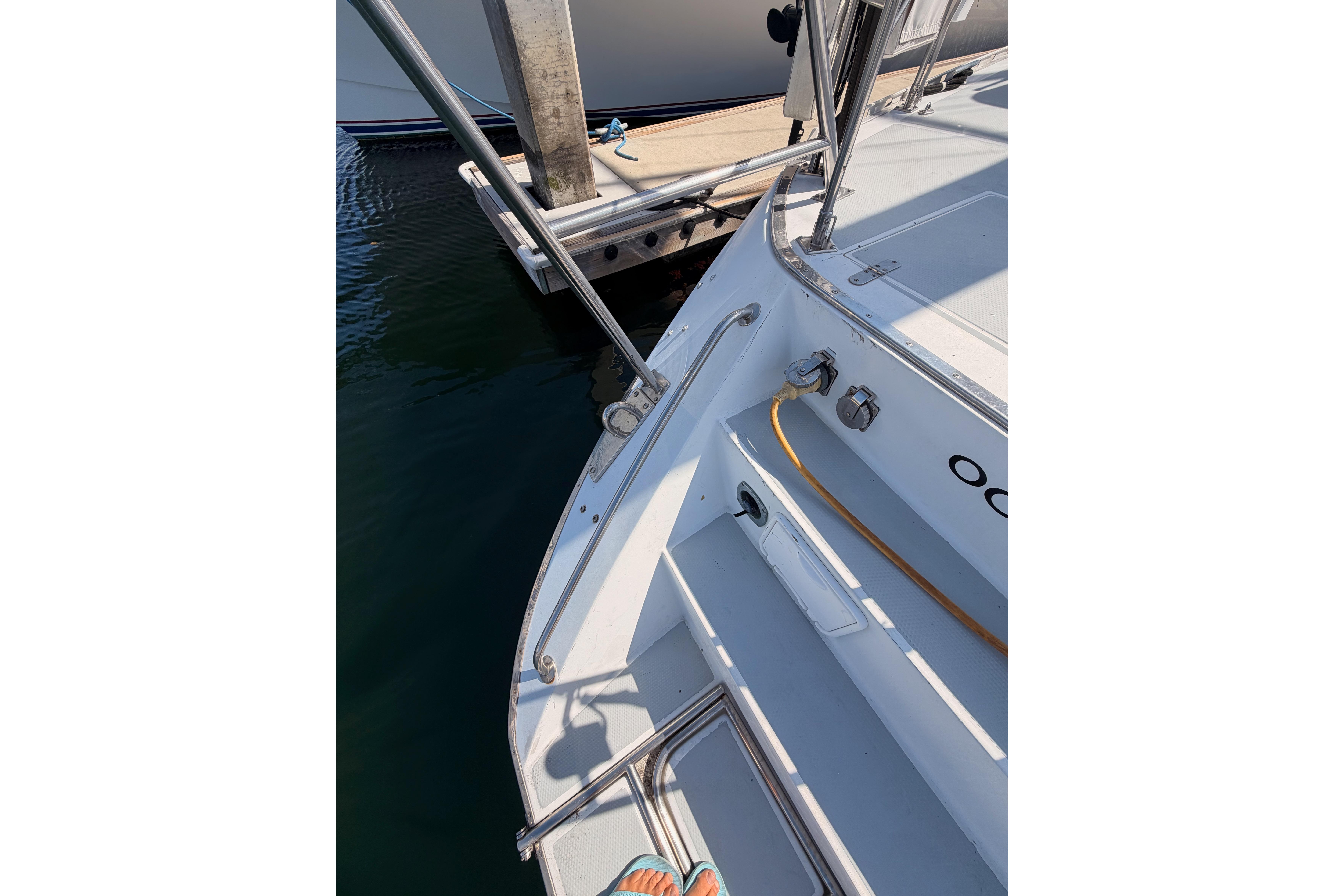 Stern view of a 1991 Hylas 51 yacht docked at a marina.