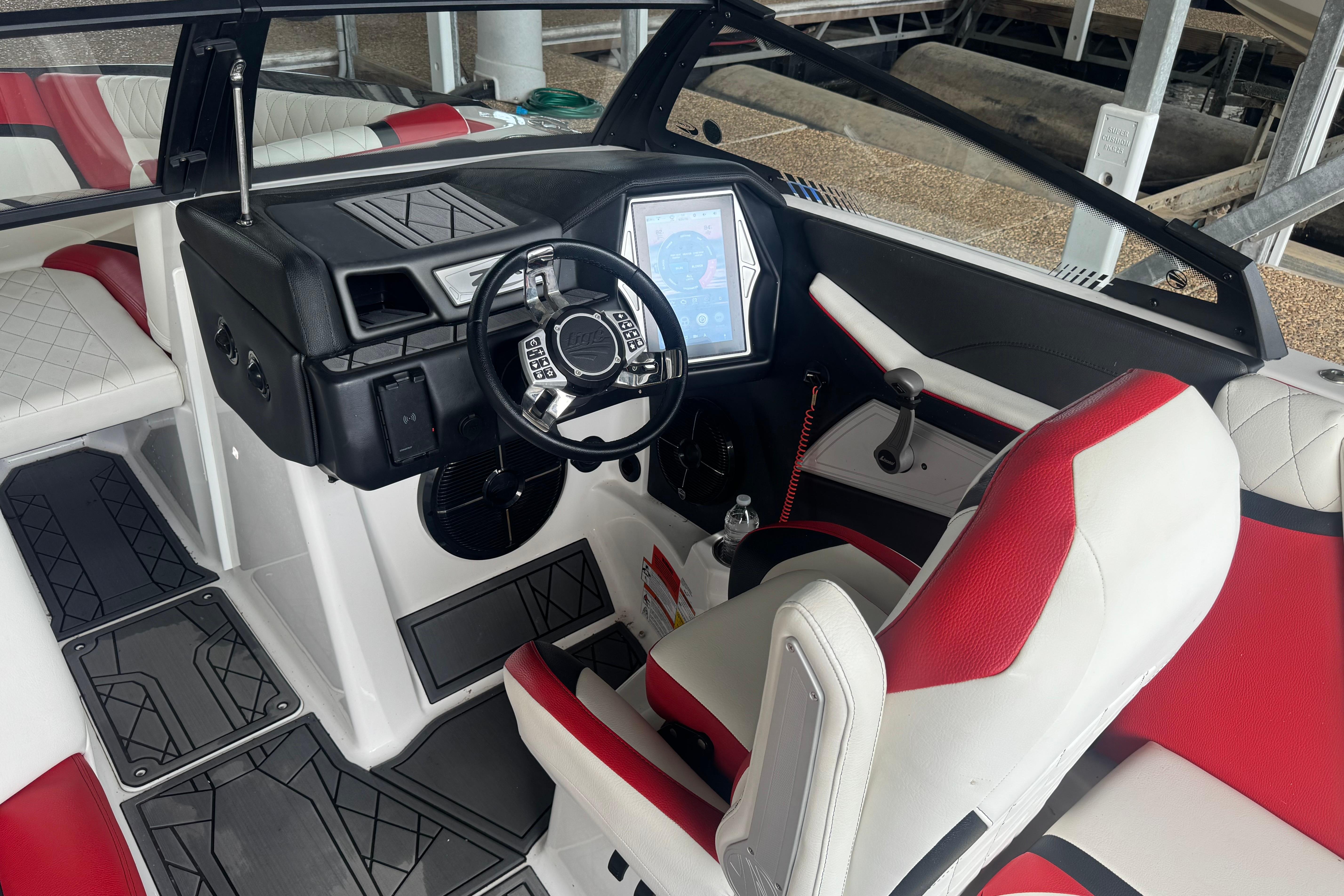 2020 Tige 25ZX boat interior with modern dashboard and red-white seating.