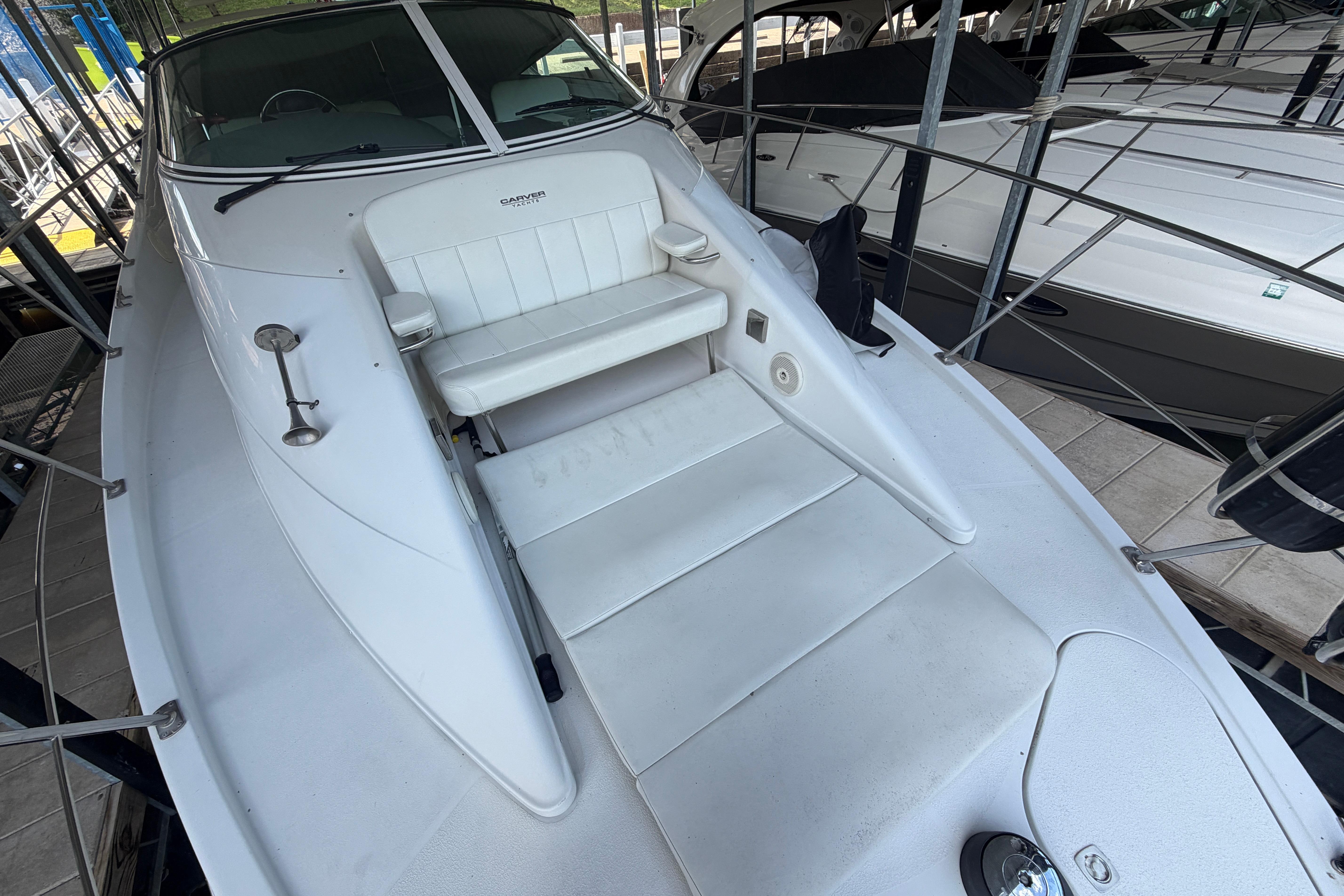 2000 Carver 350 Mariner boat with white seating and sleek design in a marina.
