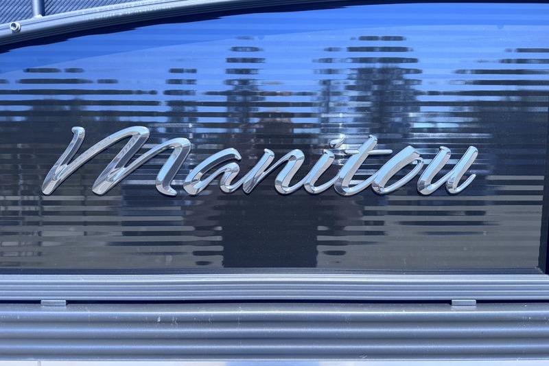 Manitou Aurora 23 RF SHP 2027 logo on sleek, reflective surface.