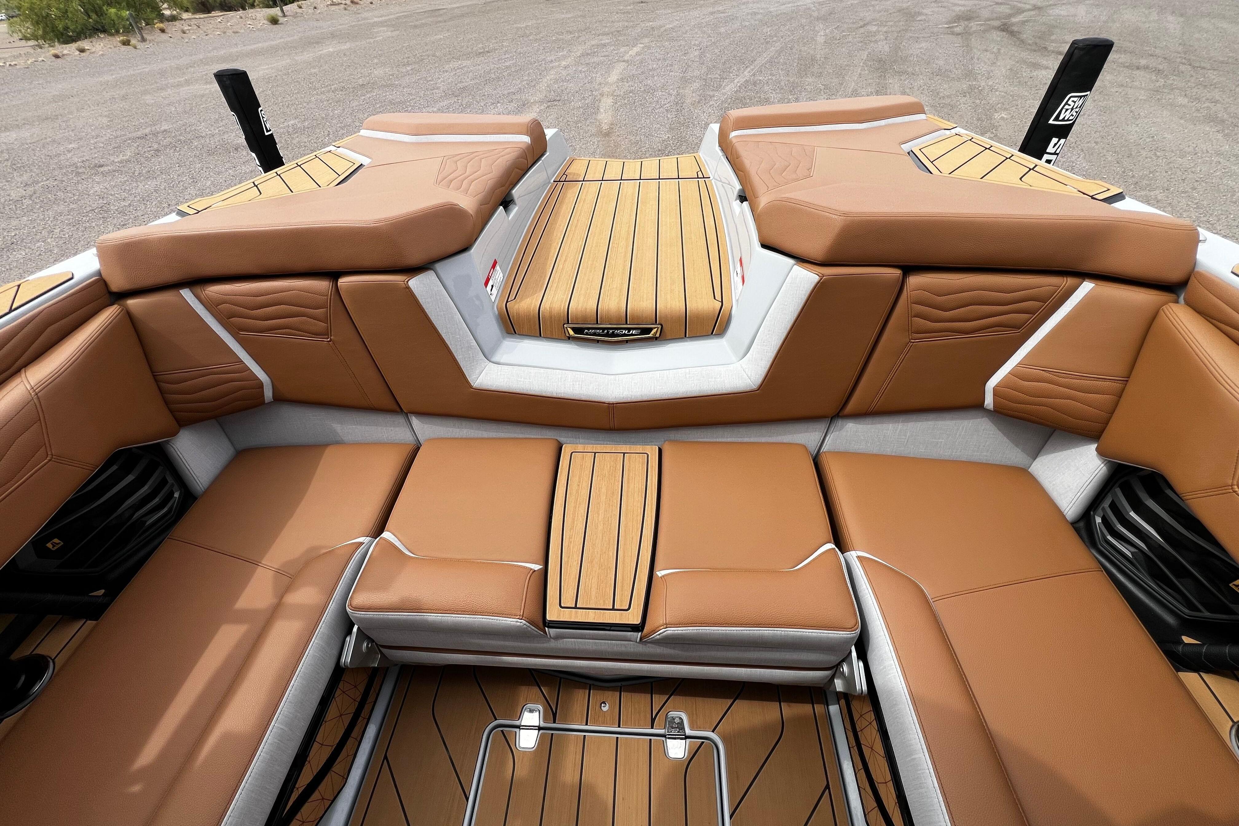 Luxurious interior of 2026 Nautique Super Air Nautique G25 boat with tan seating.