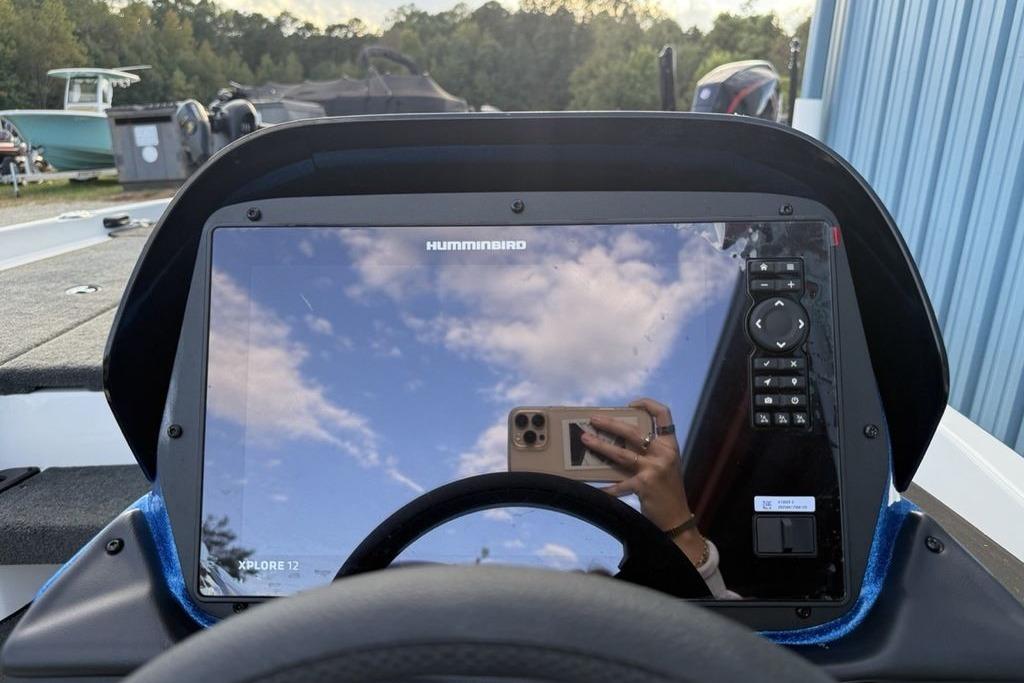 2026 Skeeter ZXR19 SE boat dashboard with Humminbird Xplore 12 display reflecting sky.