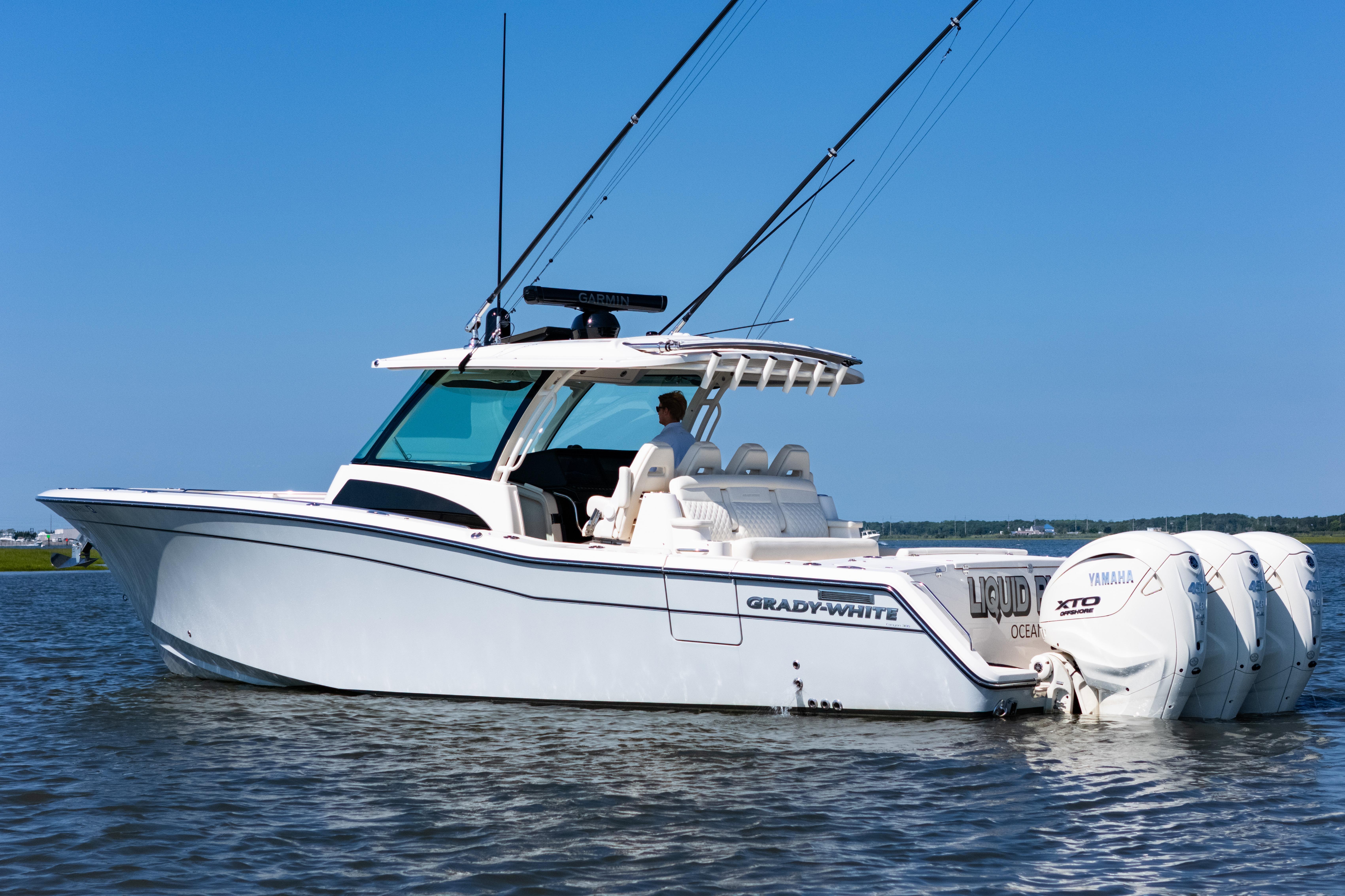 2025 Grady-White Canyon 386 boat on water, featuring Yamaha engines and sleek design.