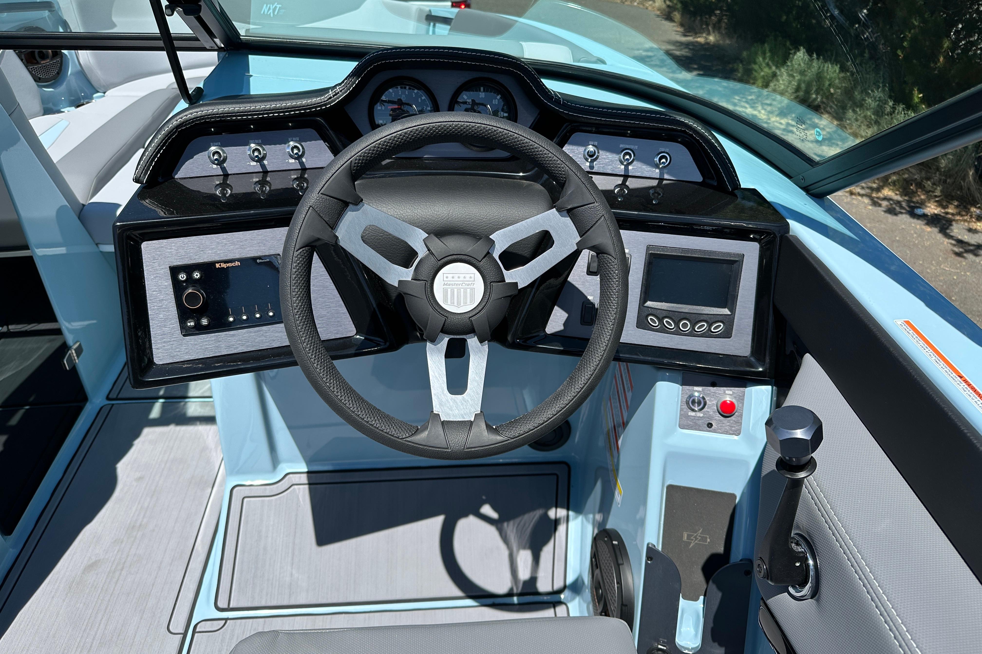 2023 MasterCraft NXT23 boat dashboard with steering wheel and control panel.
