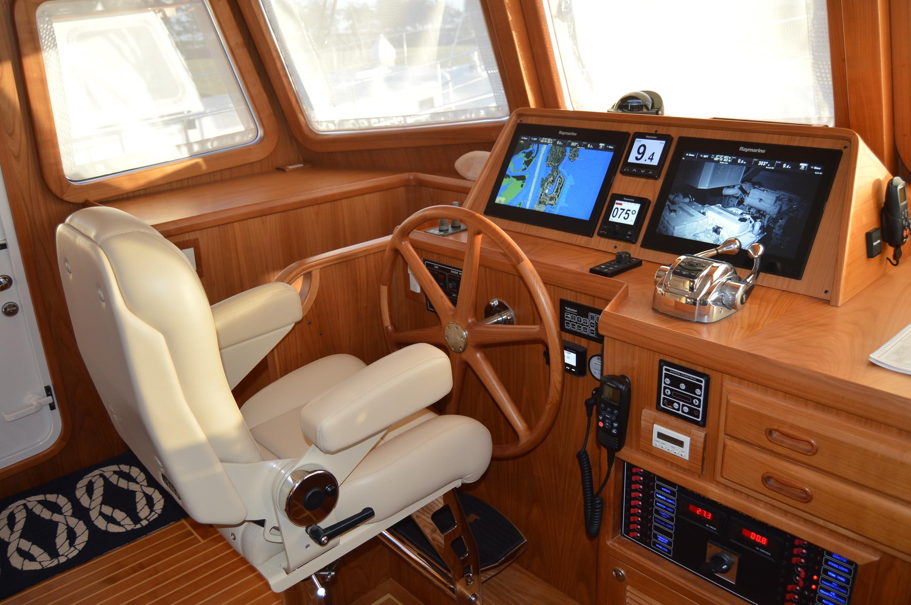 Helm of 2026 Krogen Express 52' yacht with navigation screens and controls.
