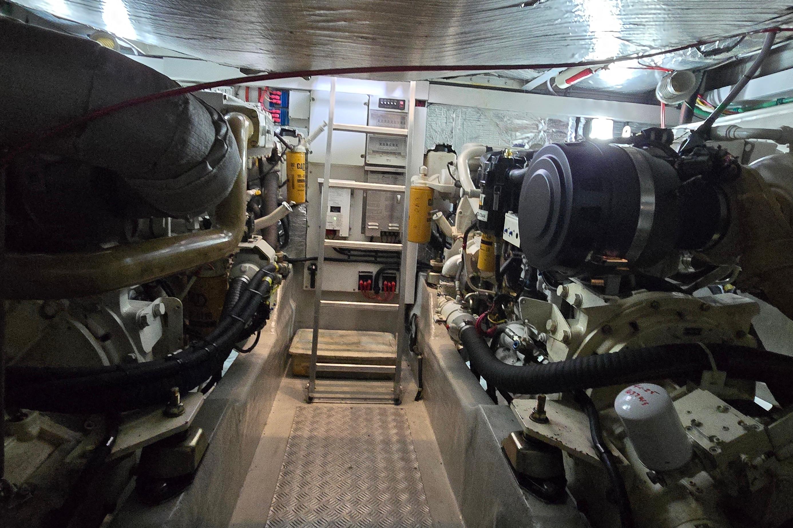 Engine room of a 2004 Sunseeker Camargue 50 yacht, showcasing dual engines and mechanical components.