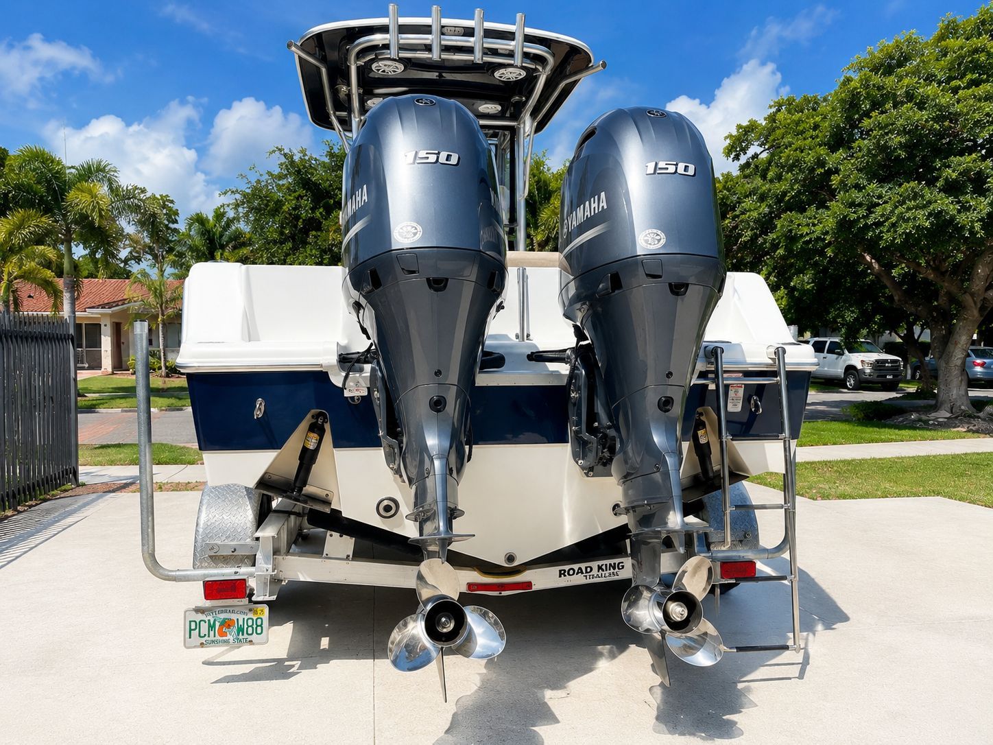 Two Yamaha outboard engines on a Sportsman Open 252 Center Console boat, parked on a trailer.