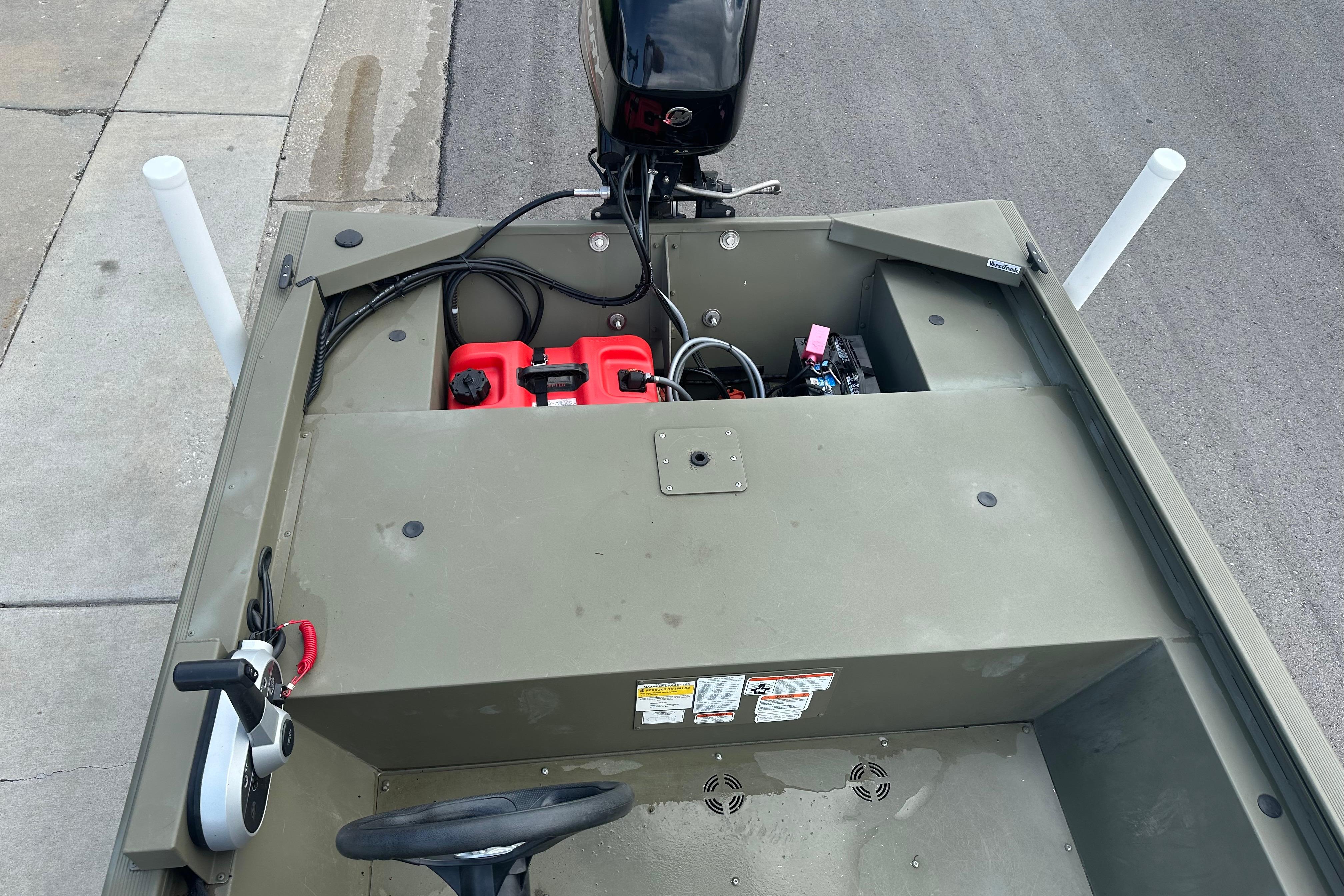 2024 Tracker Grizzly 1648 SC boat interior with steering wheel and engine controls.