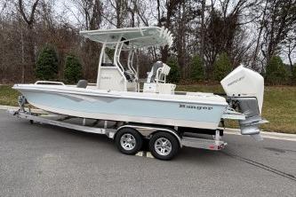 2025 Ranger 2360 Bay boat on trailer, parked outdoors, side view.