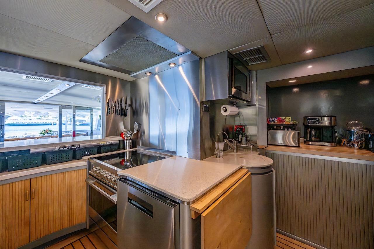 Luxurious kitchen interior on 1988 Cheoy Lee 92 yacht, featuring modern appliances and sleek design.