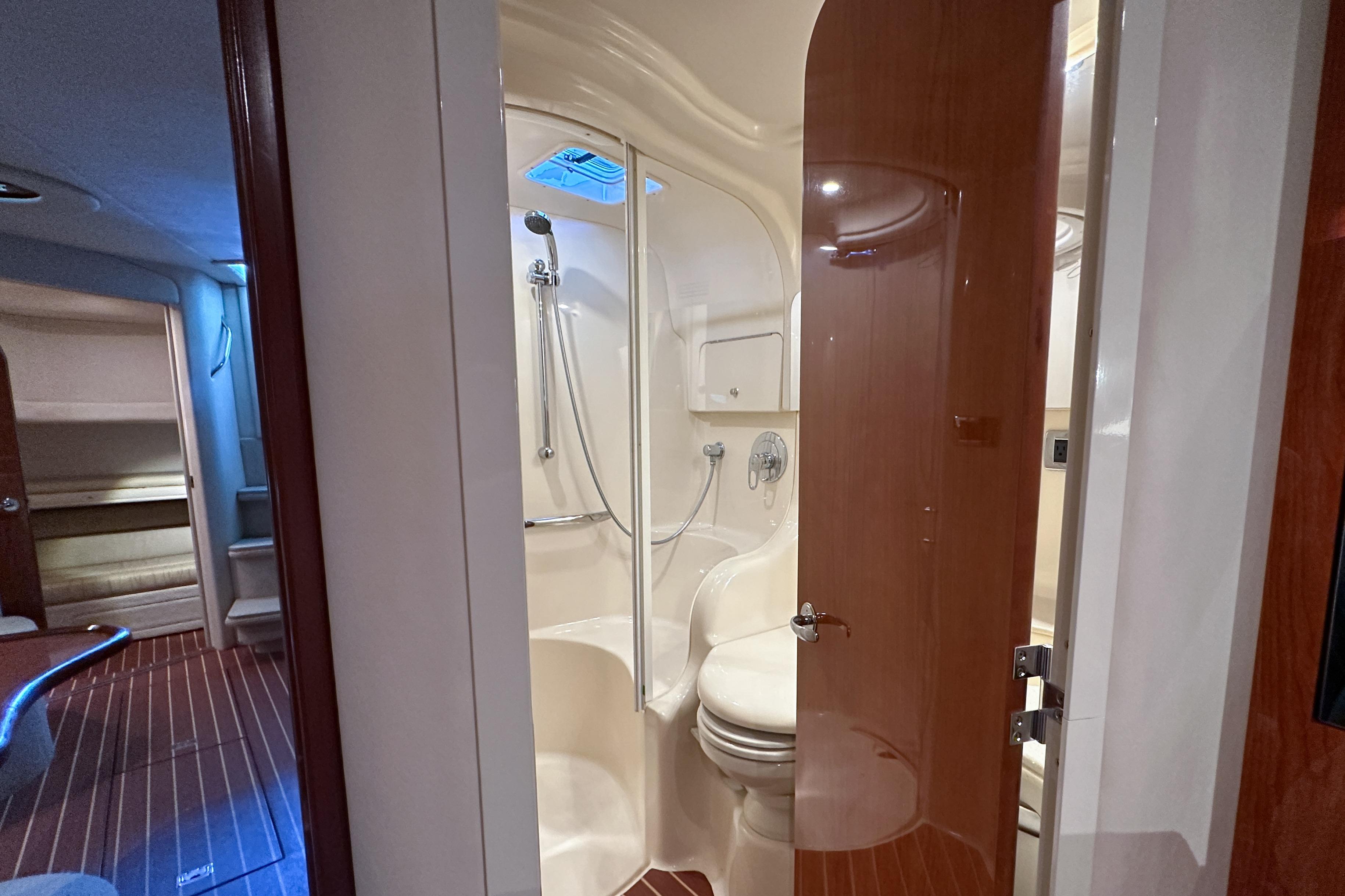 Interior of 2001 Sea Ray 410 Sundancer yacht, featuring a compact bathroom with shower.