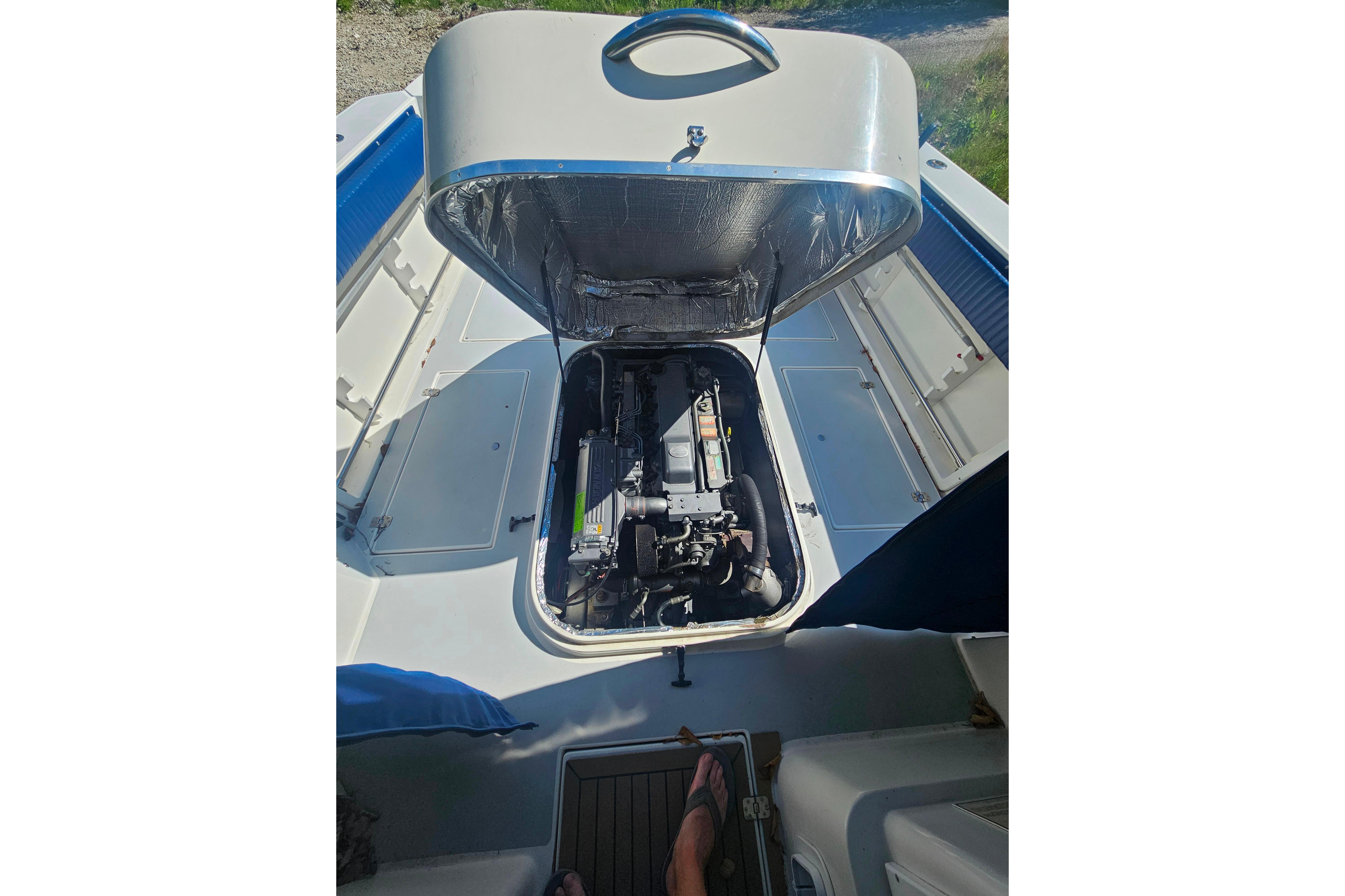 Open engine compartment of a 1999 Albin 28 Tournament Express boat.