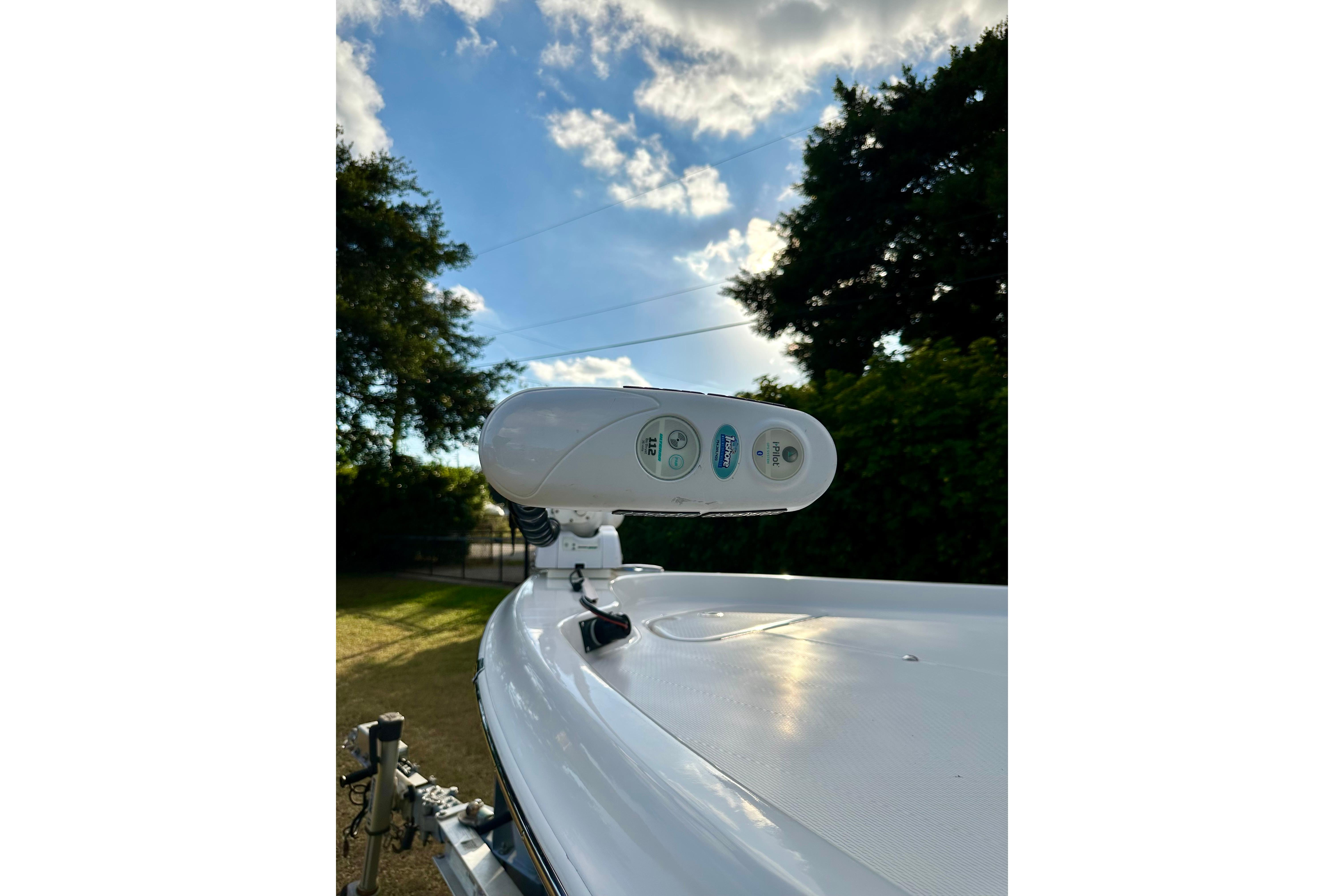 2017 Blue Wave 2400 PureBay boat with radar, under a partly cloudy sky.