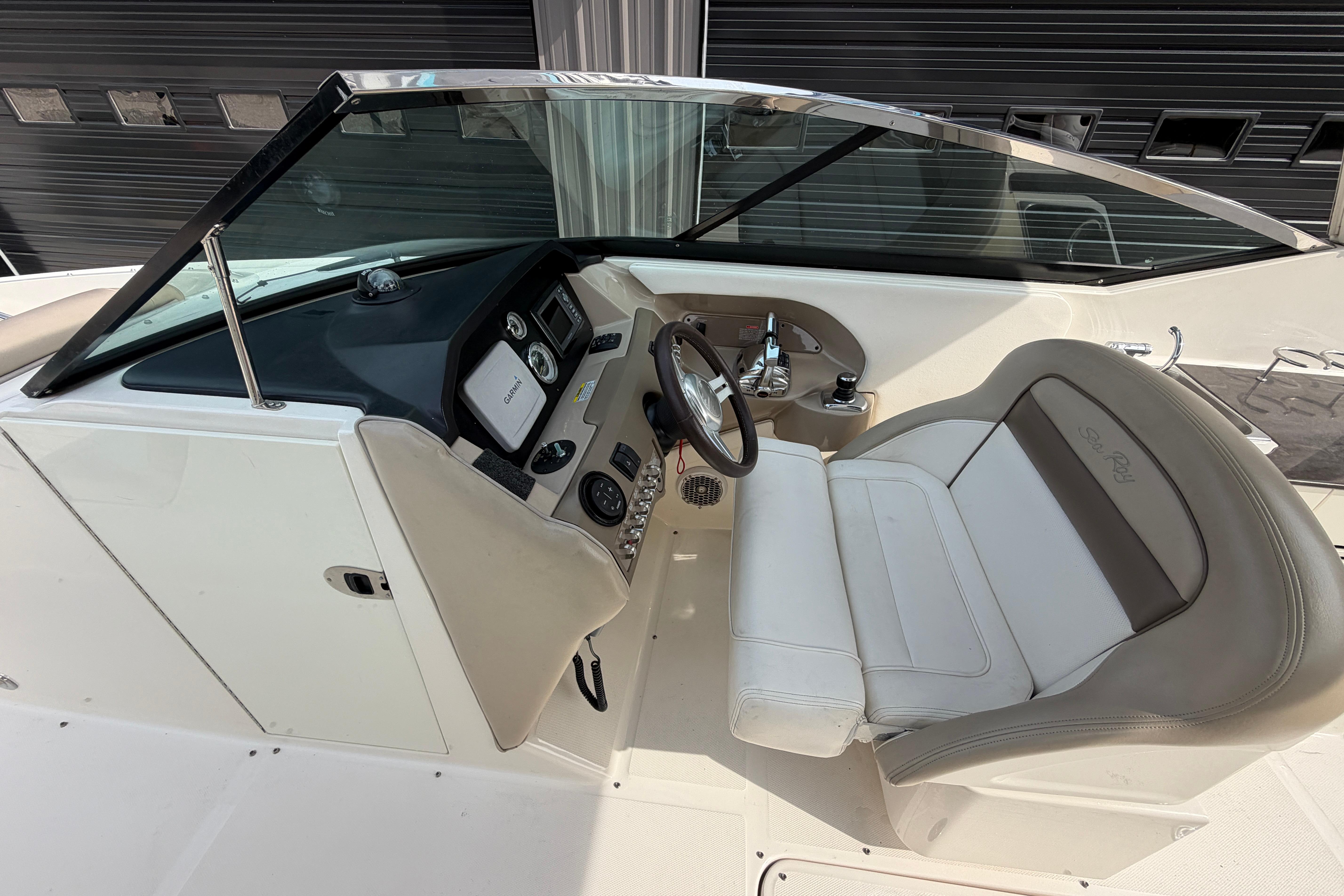 2013 Sea Ray 300 SLX boat cockpit with steering wheel and control panel.