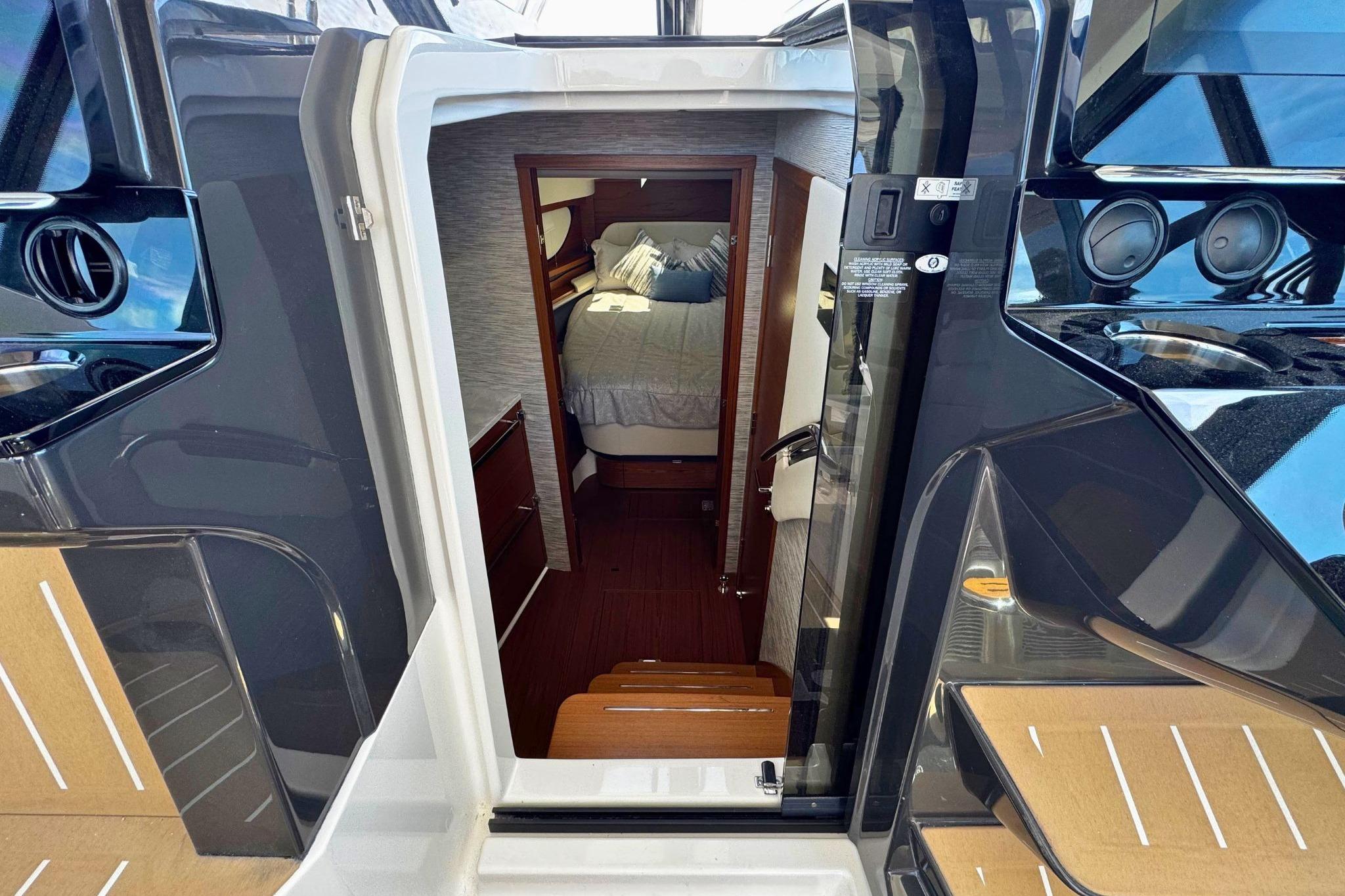 Interior view of 2027 Tiara Yachts 39 LE, showcasing cabin entrance and cozy bed.