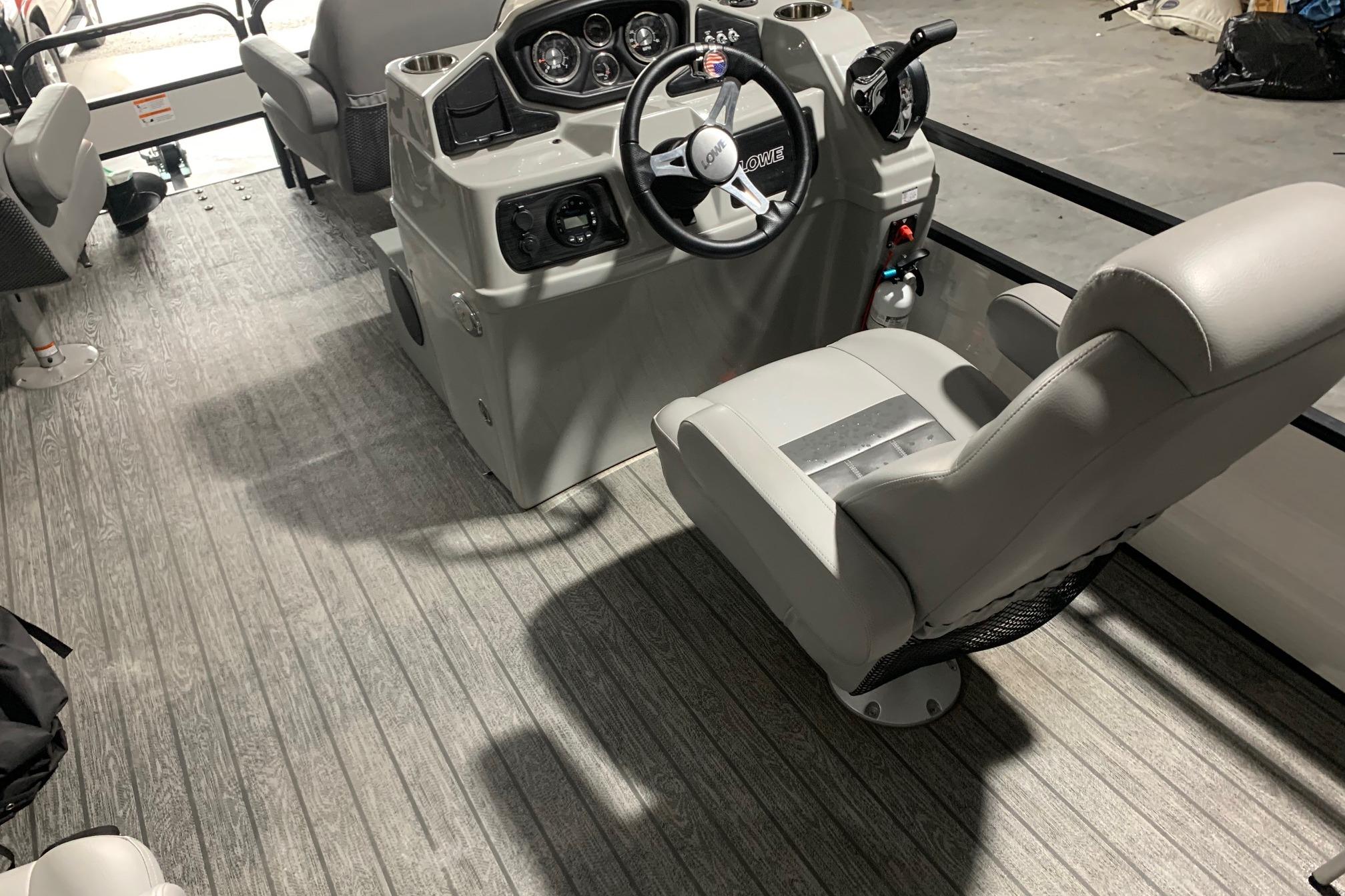 2021 Lowe SF 232 Sport Fish boat interior with steering console and seating.