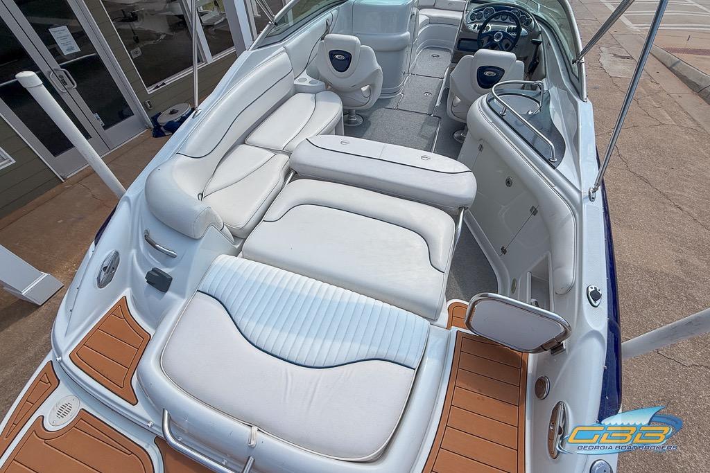 2004 Crownline 240 EX boat interior with white seating and wood accents.