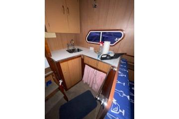 1964 Striker Model 120 boat interior with kitchenette and seating area.