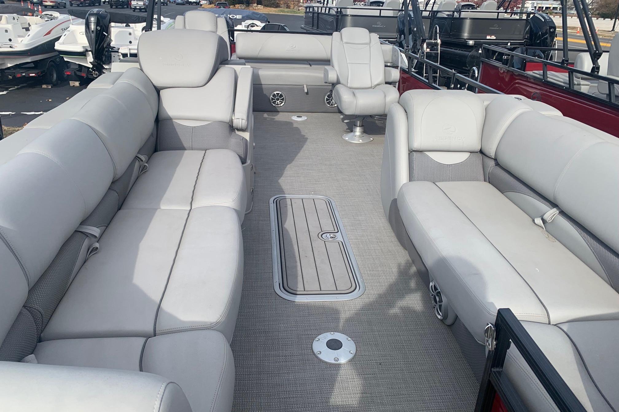 2024 Regency 250 DL3 pontoon boat interior with plush seating and spacious layout.