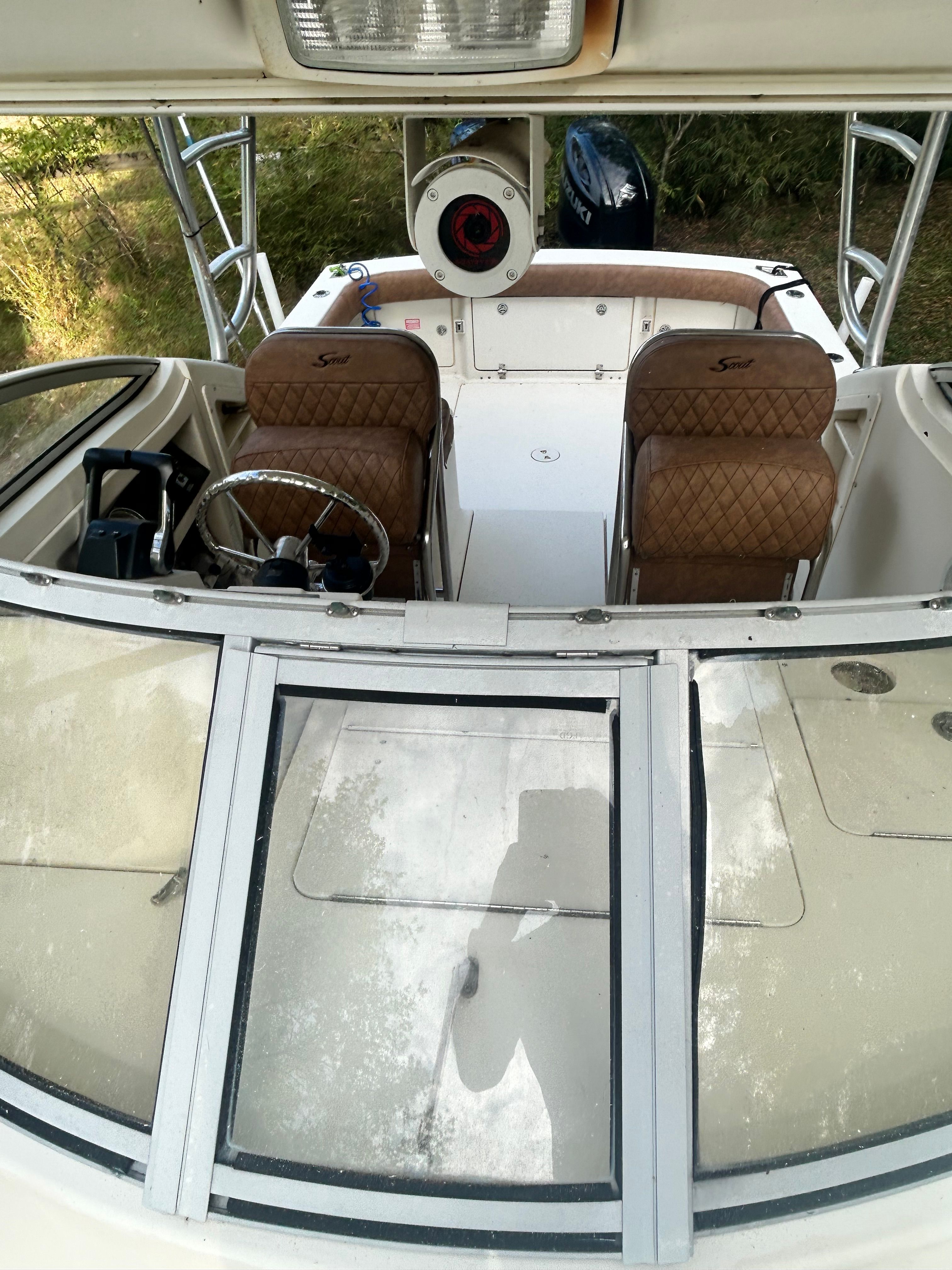 The image shows the cockpit of a 2003 Scout 280 Abaco boat with two cushioned seats.