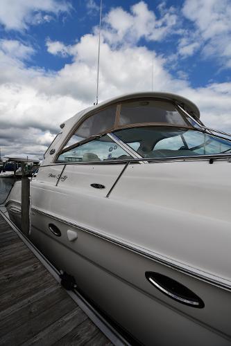 2003 Sea Ray 460 Sundancer yacht docked under a partly cloudy sky.