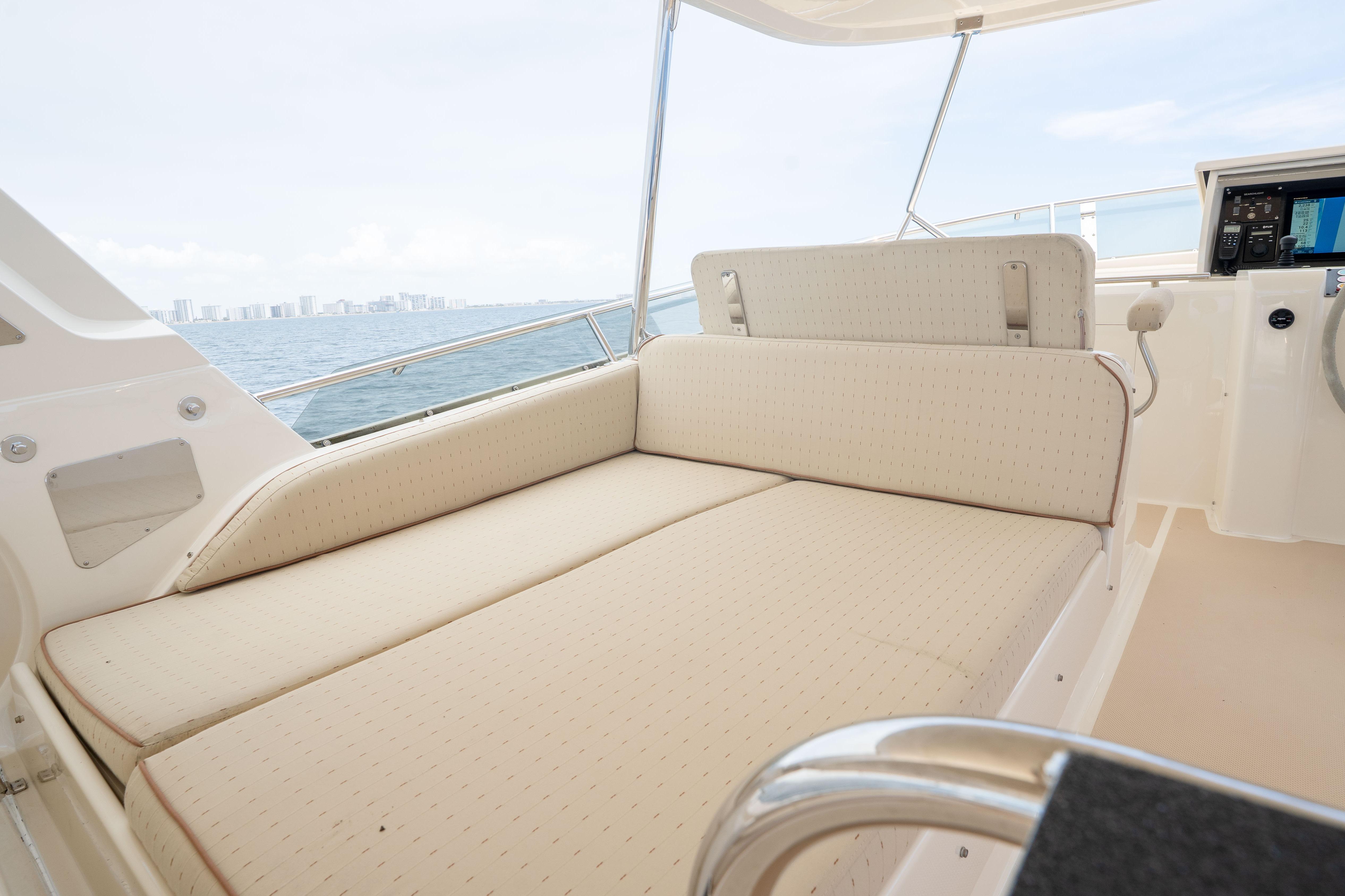 Luxurious seating area on a 2006 Fleming 75 yacht with ocean view.