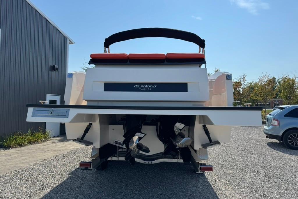 Rear view of 2020 De Antonio Yachts D28, parked on gravel.