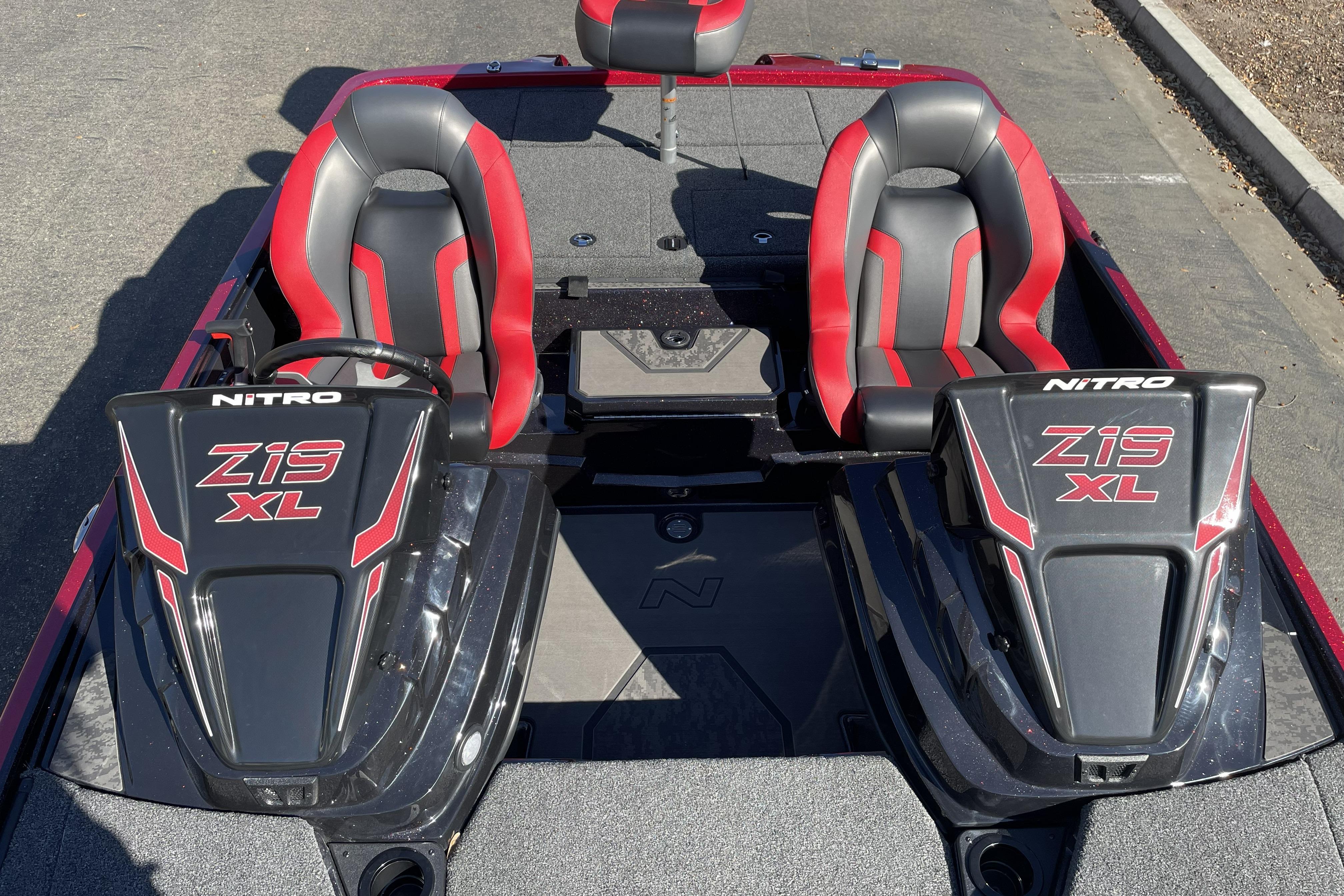 2026 Nitro Z19 XL boat interior with red and black seats, steering consoles.