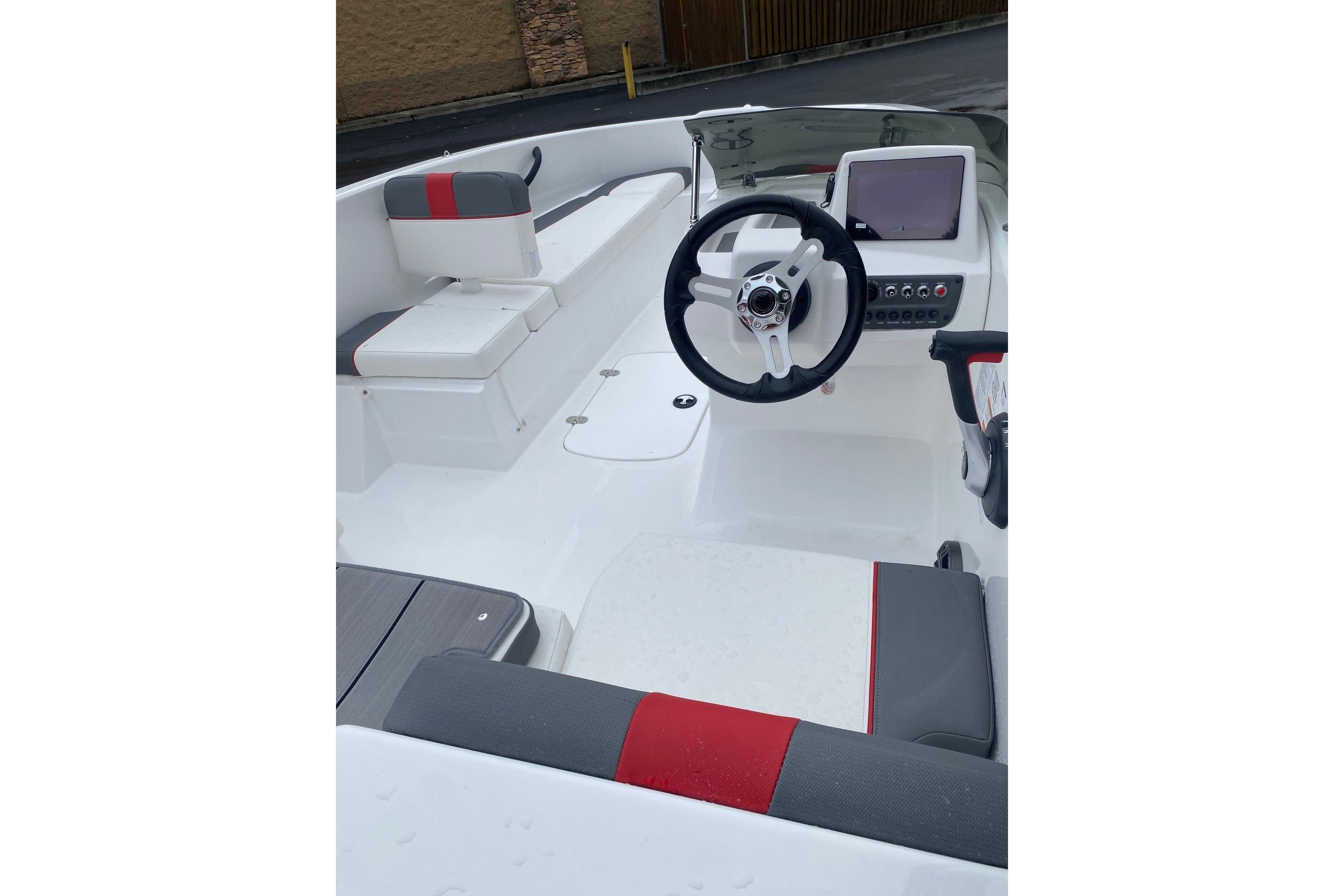 2026 Tahoe T16 boat interior with steering wheel and seating, featuring modern design elements.