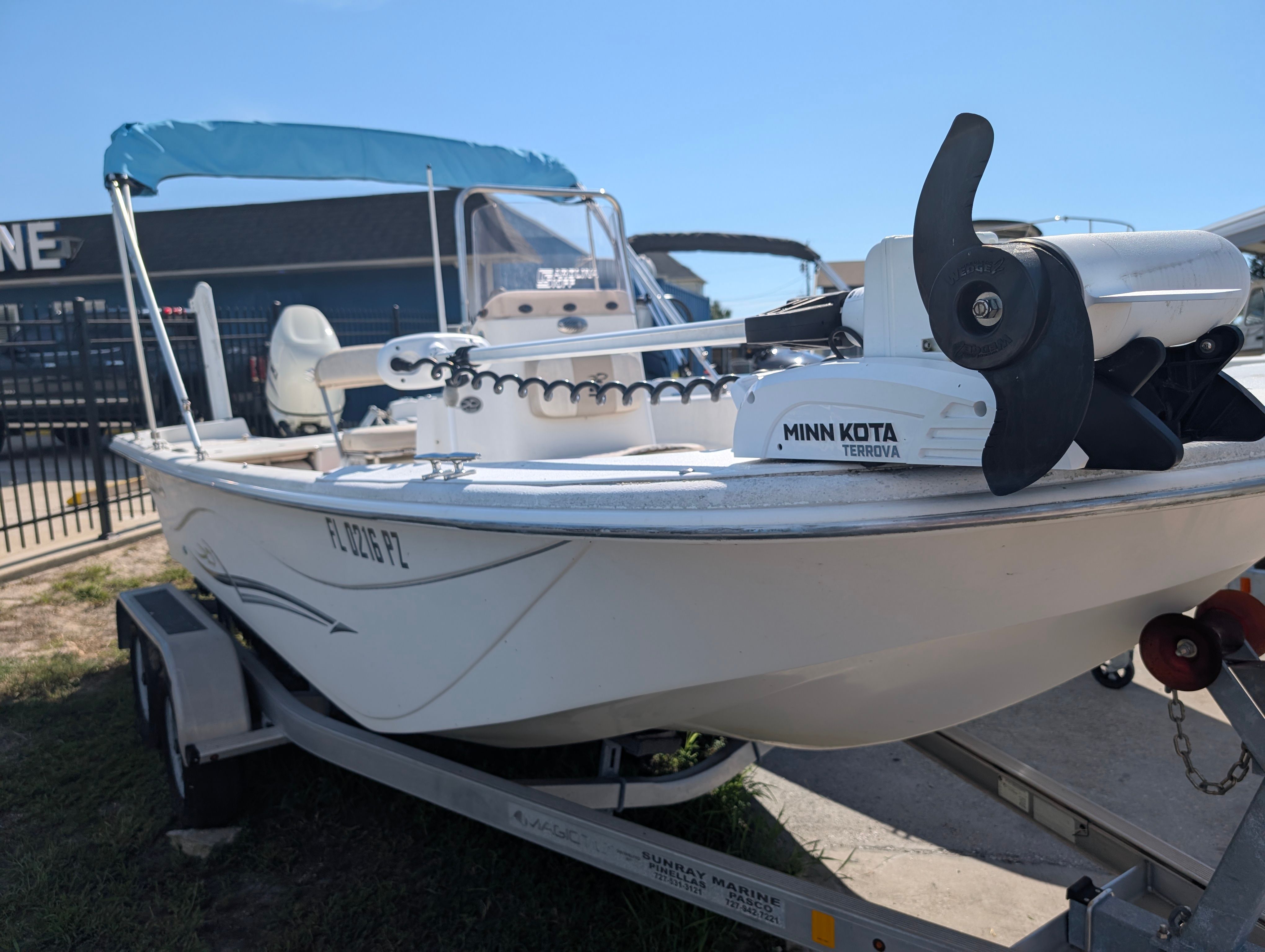 A 2016 Carolina Skiff 198 DLV boat on a trailer with a Minn Kota trolling motor.