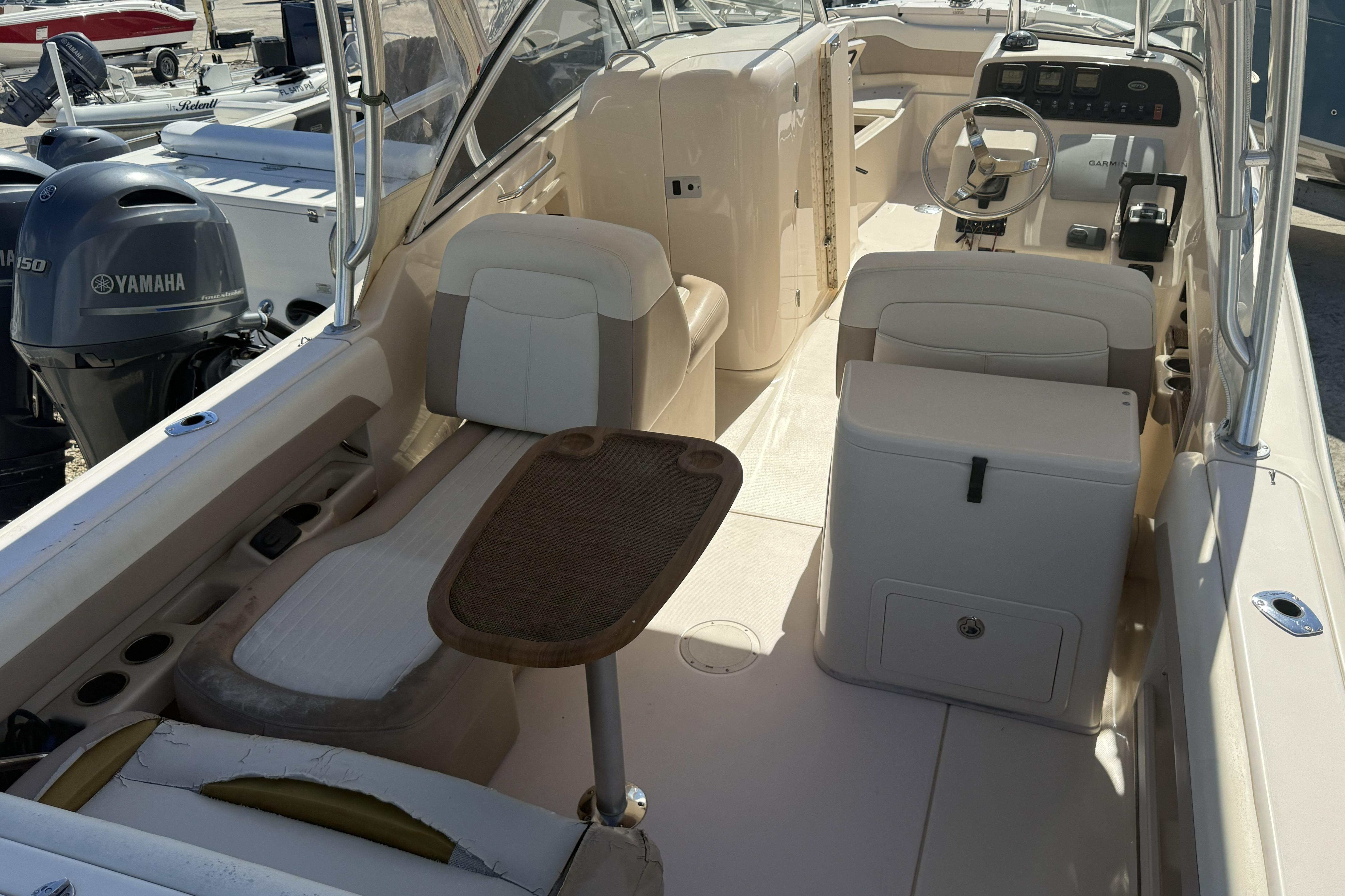 2014 Grady-White Freedom 275 boat interior with seating, table, and Yamaha outboard motor.