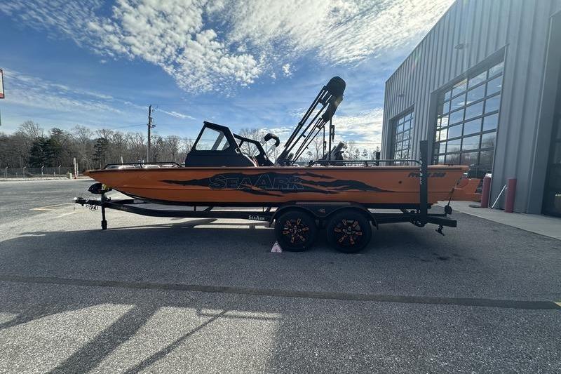 2026 SeaArk ProCat 240 boat on trailer, parked outdoors under a partly cloudy sky.