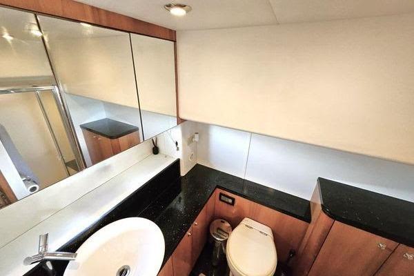 Luxurious bathroom interior of 2005 Sunseeker Manhattan 66 yacht with modern fixtures.