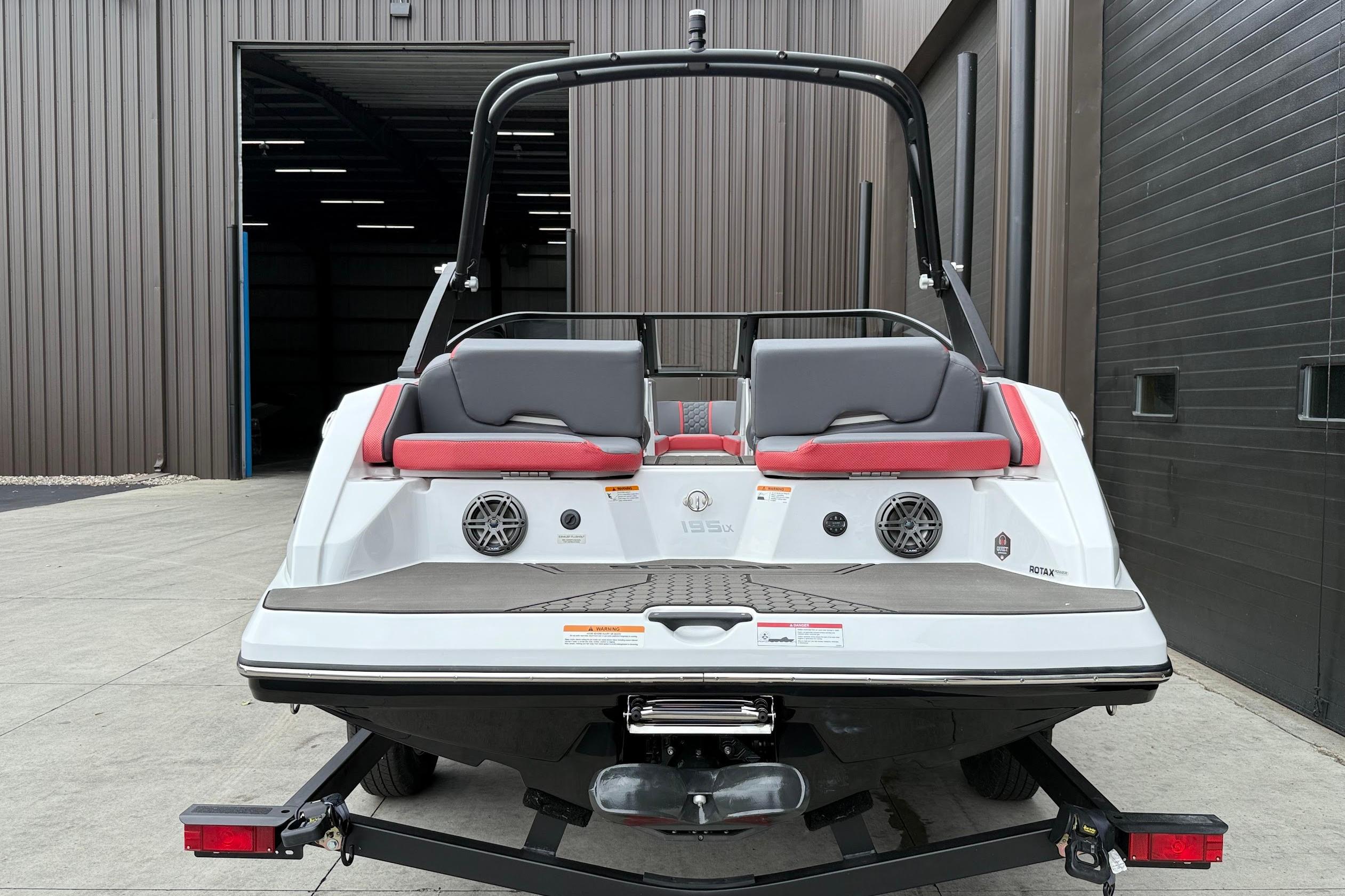 2026 Scarab 195 LX boat rear view, featuring sleek design and modern seating.