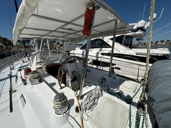 Concordia 52 sailboat, 1989 model, docked at marina with covered cockpit and steering wheel.