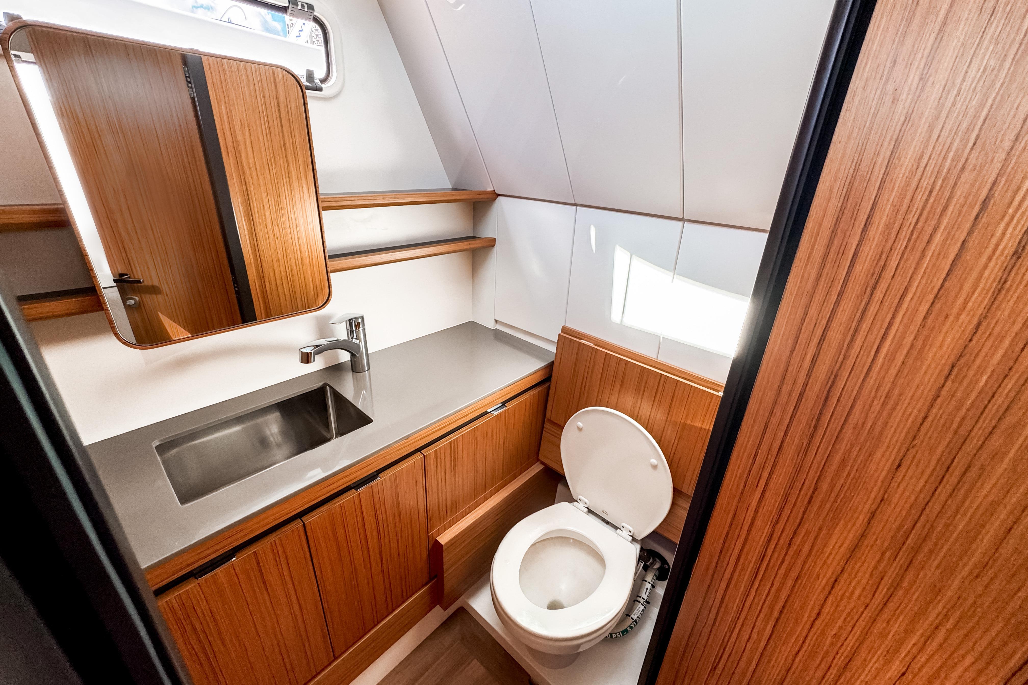 Modern bathroom in 2025 Aiata Wayfinder 38 Cabin yacht, featuring wood accents and sleek fixtures.