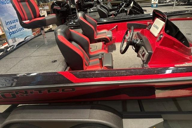 2026 Nitro Z20 XL Pro boat with red and black seating, steering console, and spacious deck.