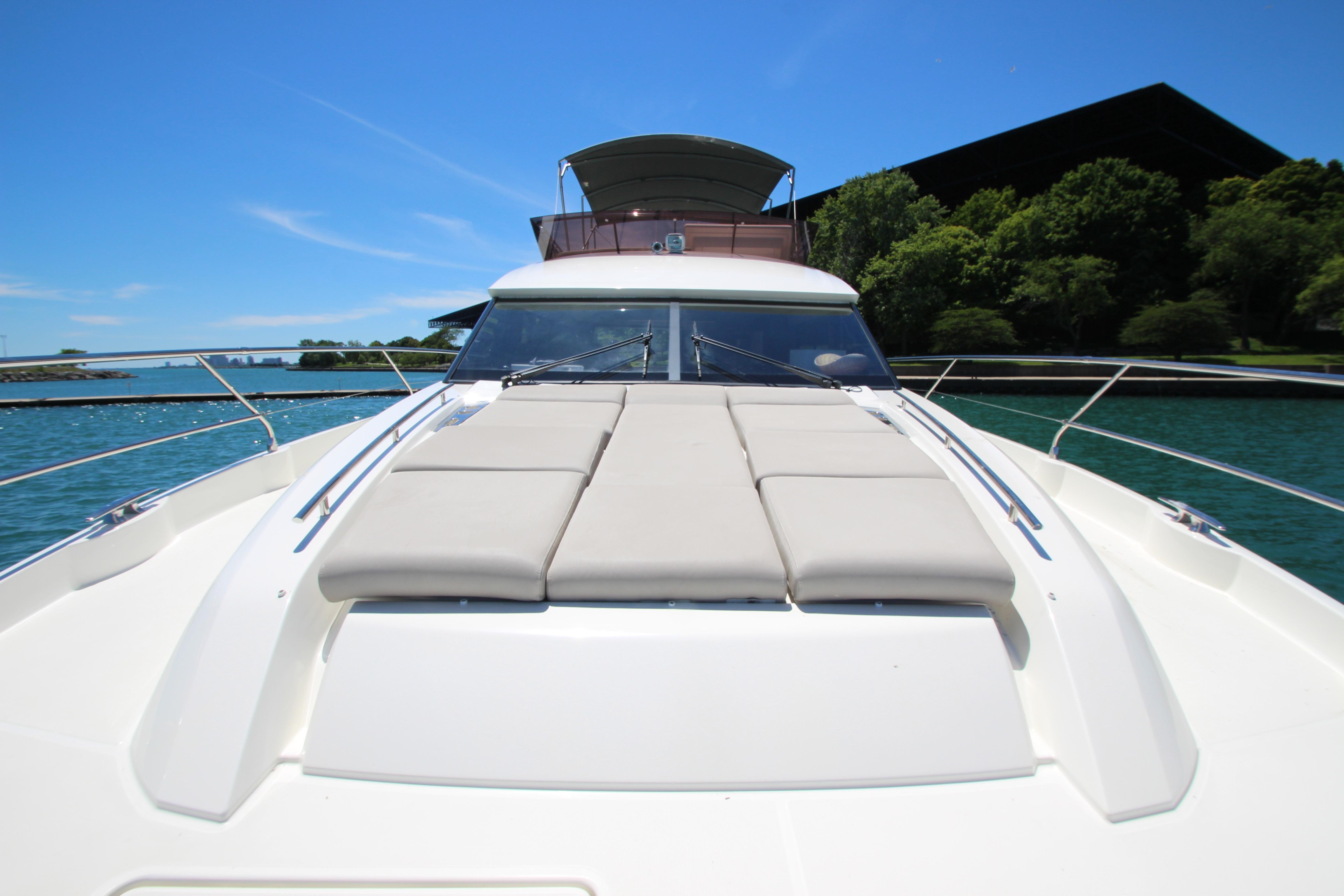 2022 Prestige 520 yacht on water, featuring sleek design and sunbathing area.