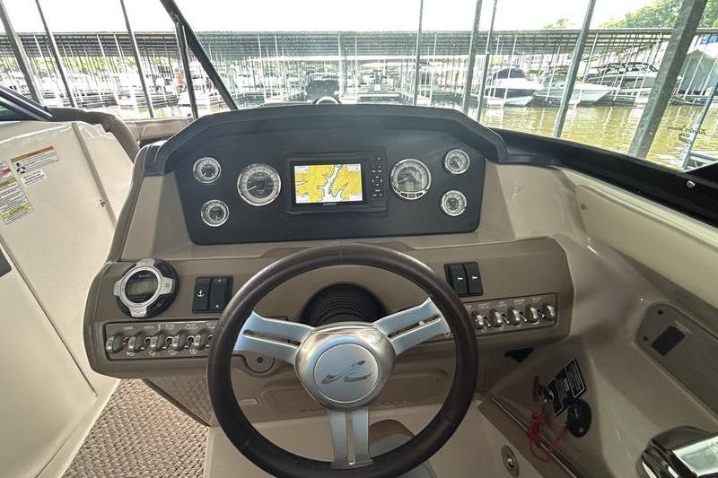 Steering console of a 2011 Sea Ray 300 SLX boat with navigation display.