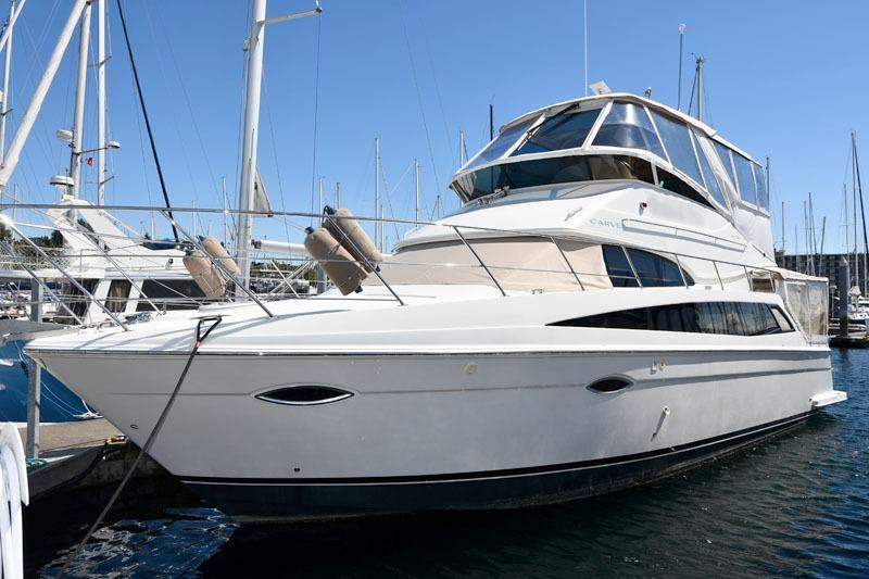 2008 Carver 43 Super Sport yacht docked at marina under clear blue sky.
