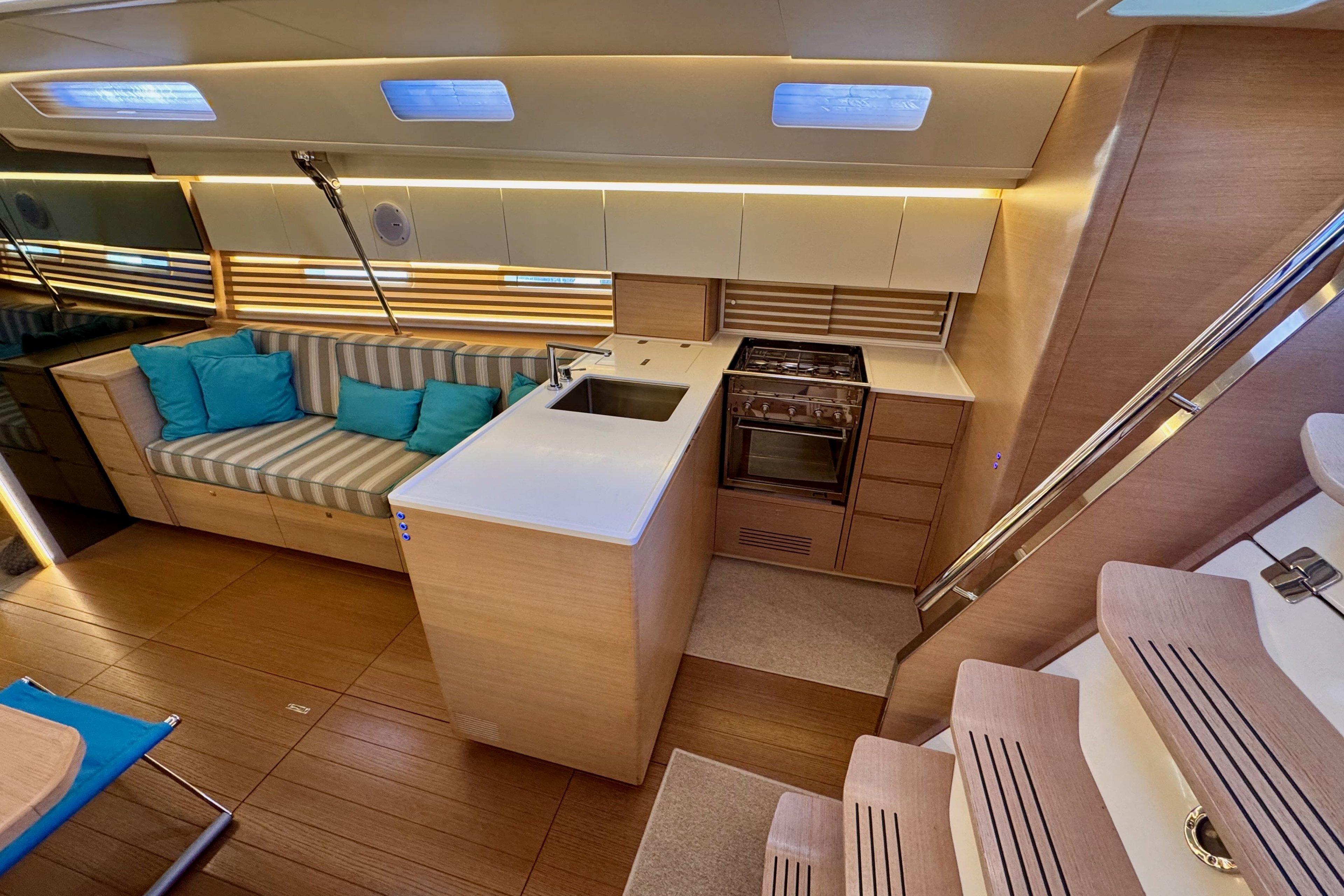 Modern interior of 2021 Italia Yachts 15.98 with sleek kitchen and cozy seating area.