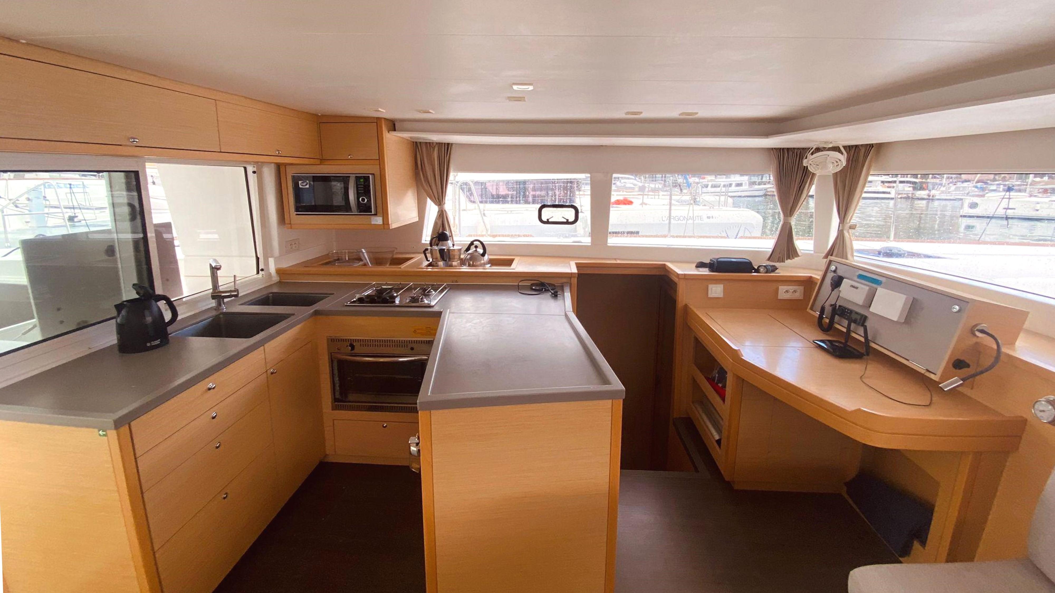 Interior of 2017 Lagoon 450 F catamaran kitchen with modern appliances and ample counter space.