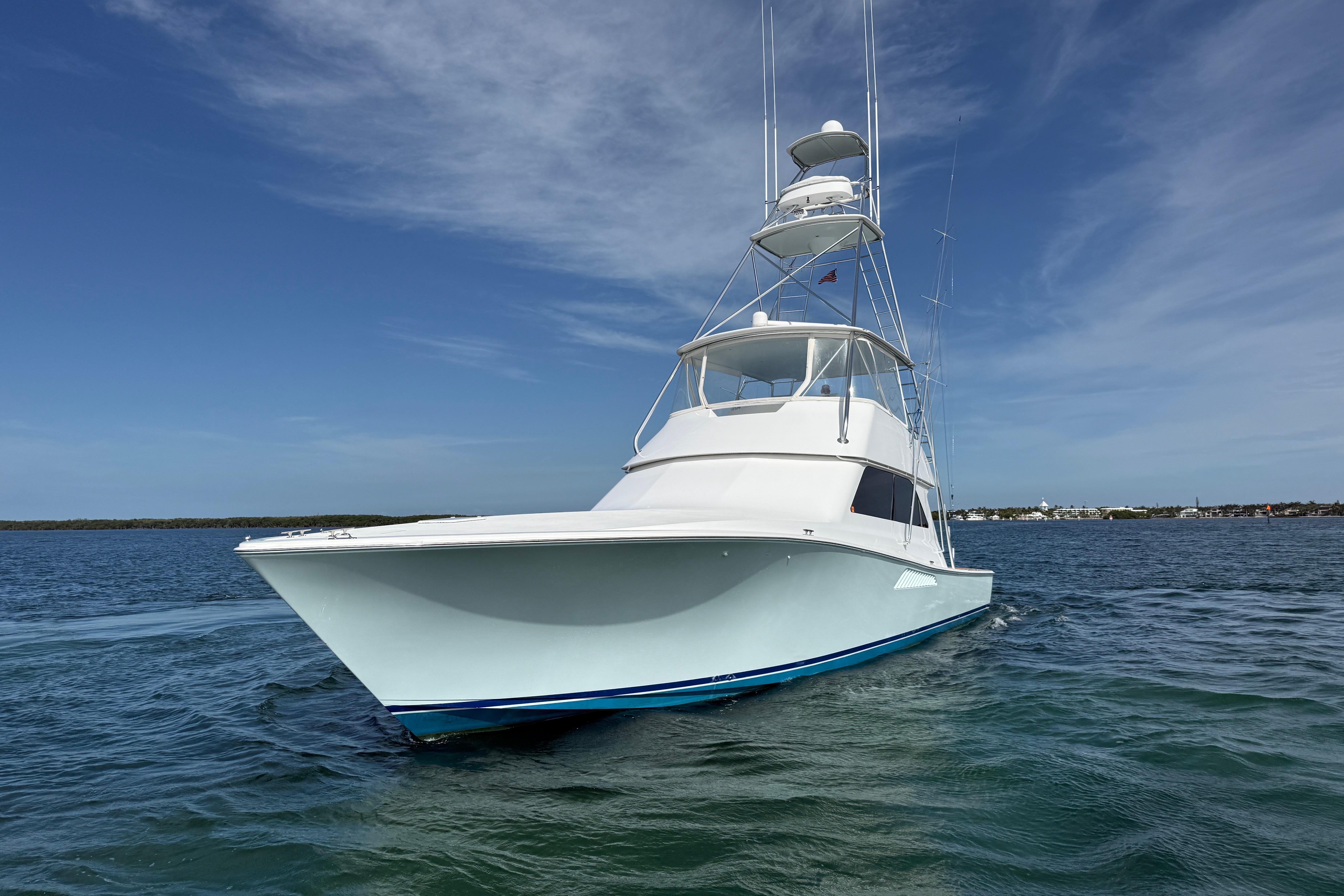 2000 Viking 55 Convertible yacht cruising on open water under clear blue skies.